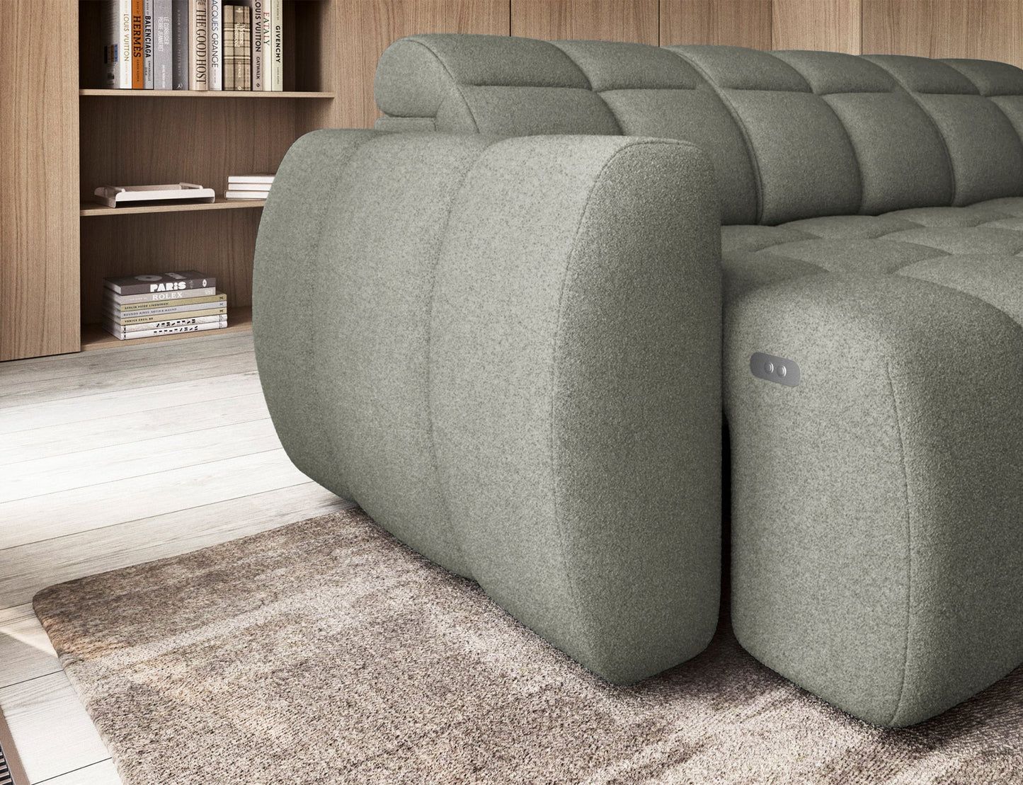 Zbliżenie na boczek narożnika Xillar 100 w jasnozielonej tkaninie z widocznym przyciskiem sterującym wysuwem siedziska.