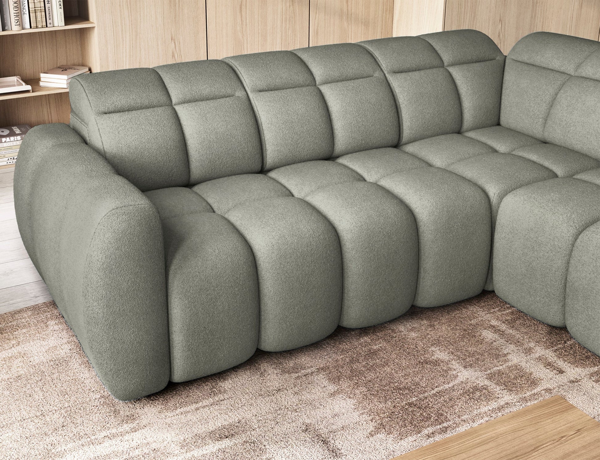 Zbliżenie na narożnik Xillar 100 w jasnozielonym kolorze z wysuniętym siedziskiem, ukazujące pikowane detale i miękką tapicerkę.