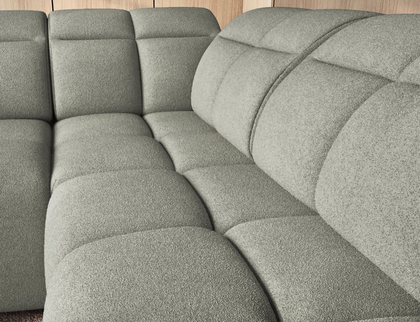 Zbliżenie na siedzisko narożnika Xillar 100 w jasnozielonej tkaninie, z wyraźnie widoczną miękką pikowaną strukturą.