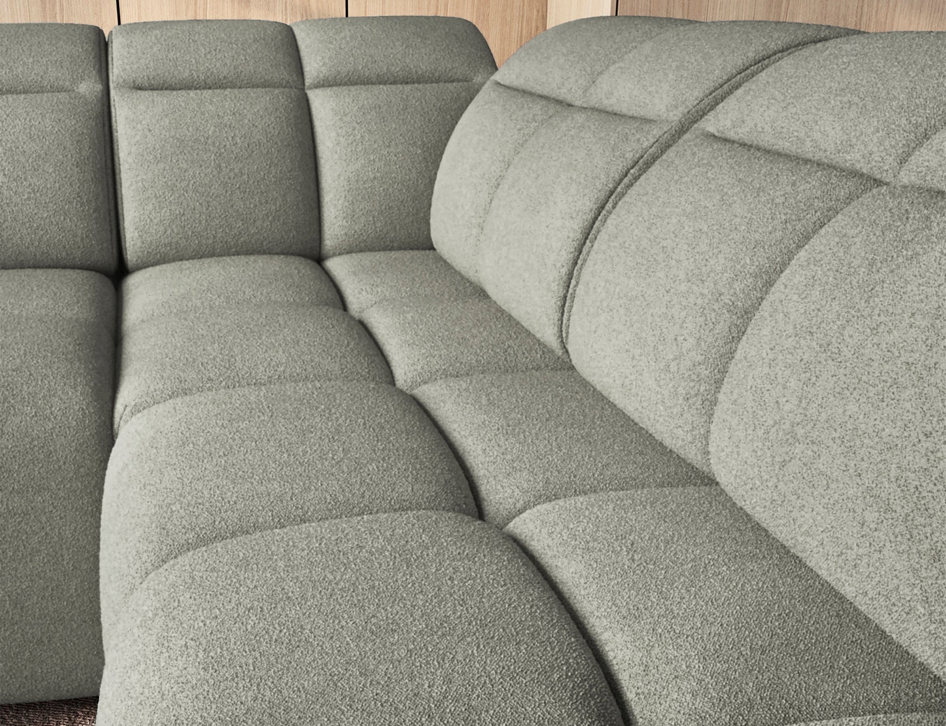 Zbliżenie na siedzisko narożnika Xillar 100 w jasnozielonej tkaninie, z wyraźnie widoczną miękką pikowaną strukturą.