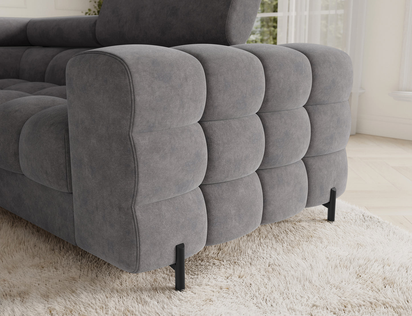 Detal narożnika Fectory w kolorze szarym z widocznymi metalowymi nogami, podkreślającymi nowoczesny styl mebla.