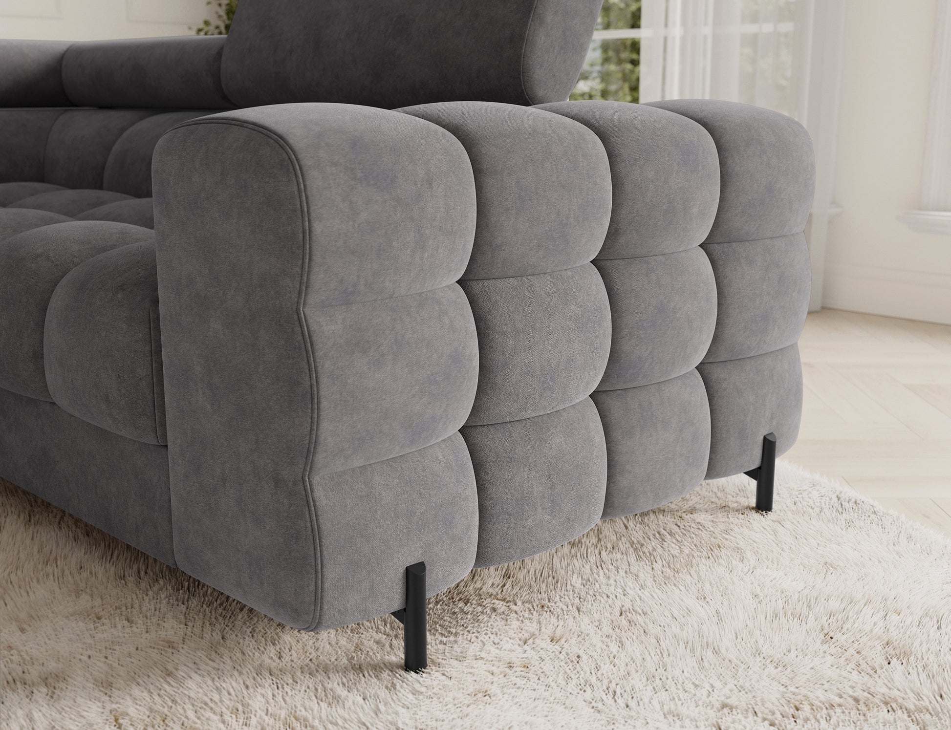 Detal narożnika Fectory w kolorze szarym z widocznymi metalowymi nogami, podkreślającymi nowoczesny styl mebla.