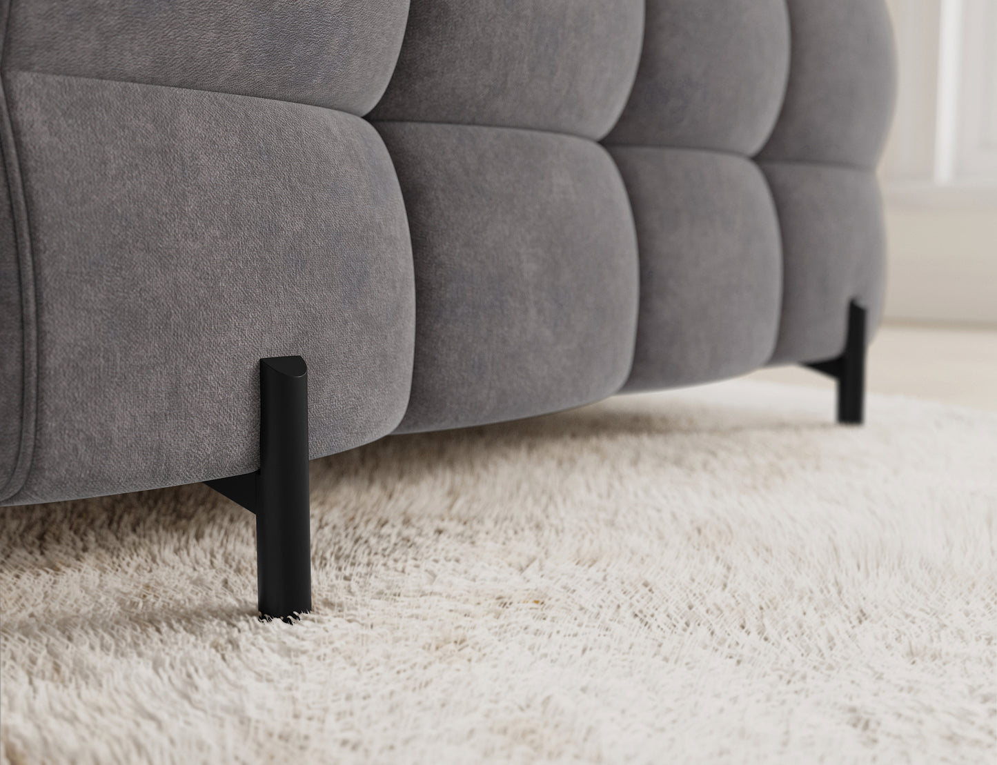 Zbliżenie na metalowe nogi narożnika Fectory, doskonale kontrastujące z szarym tapicerowanym materiałem.
