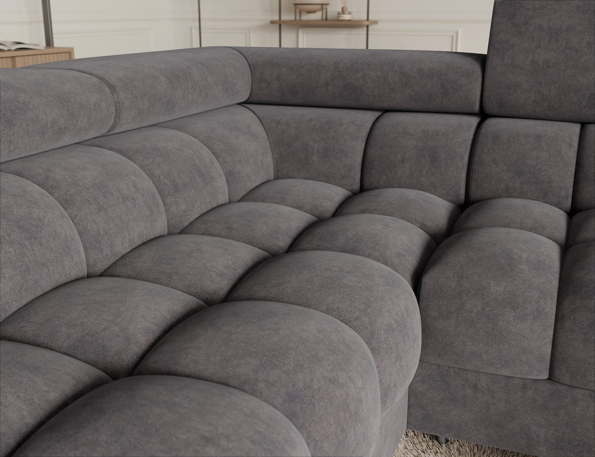 Detal tapicerki narożnika Fectory w szarym odcieniu, prezentujący elegancki, nowoczesny design mebla.