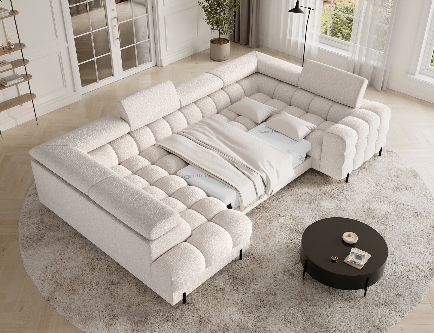 Narożnik Fectory Baffix 20 beżowy z rozłożoną funkcją spania – szeroka powierzchnia z pościelą.