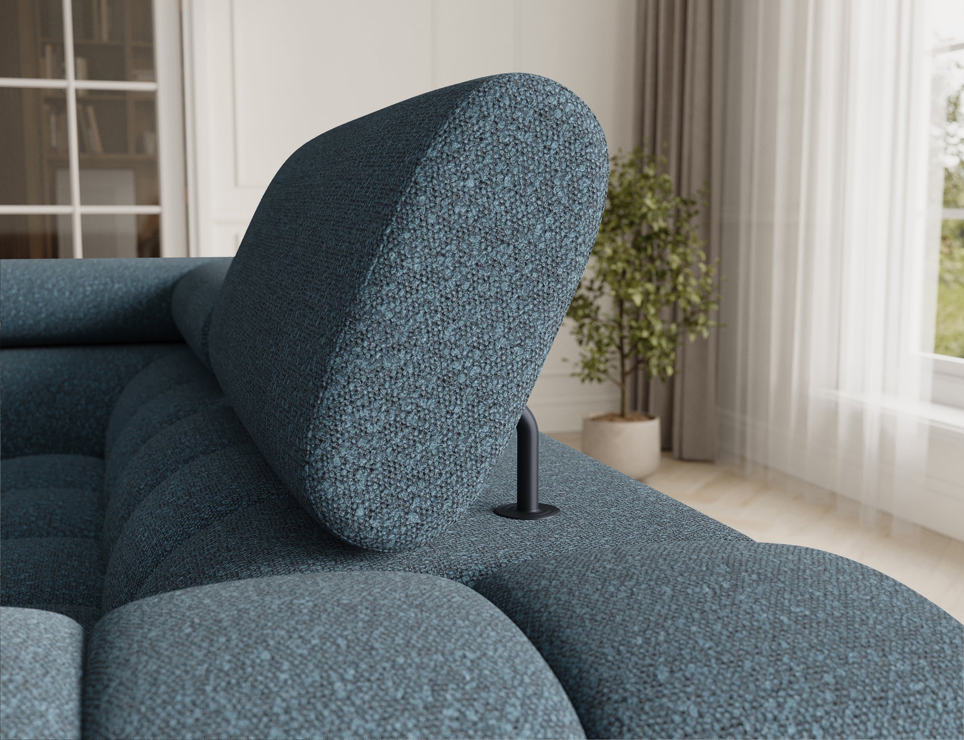 Zbliżenie na zagłówek narożnika Fectory w odcieniu niebieskim, z regulowaną częścią, zapewniającą wygodę użytkowania.