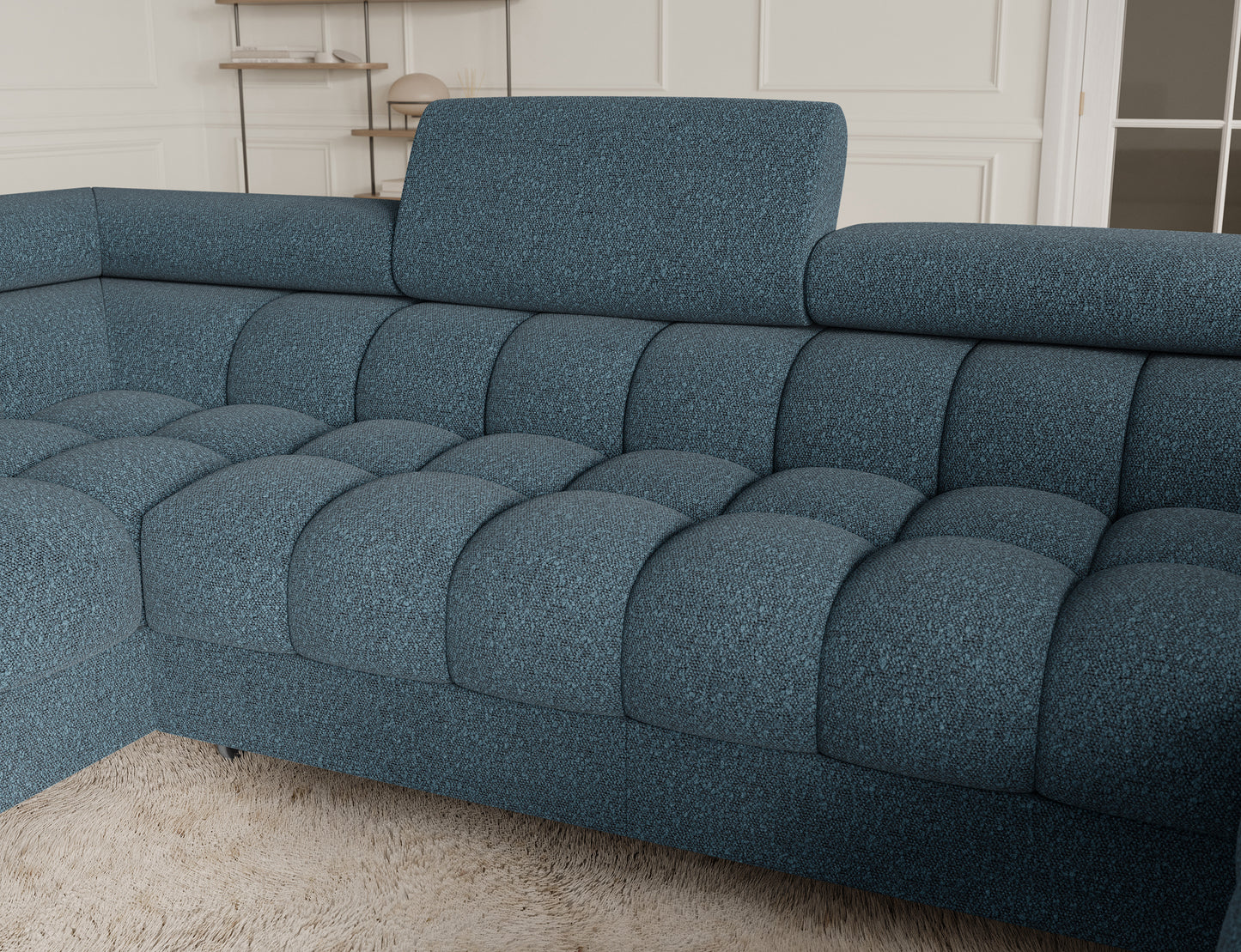 Zbliżenie na narożnik Fectory w niebieskim kolorze, ukazujące detale tapicerki oraz elegancki wygląd mebla z metalowymi nogami.