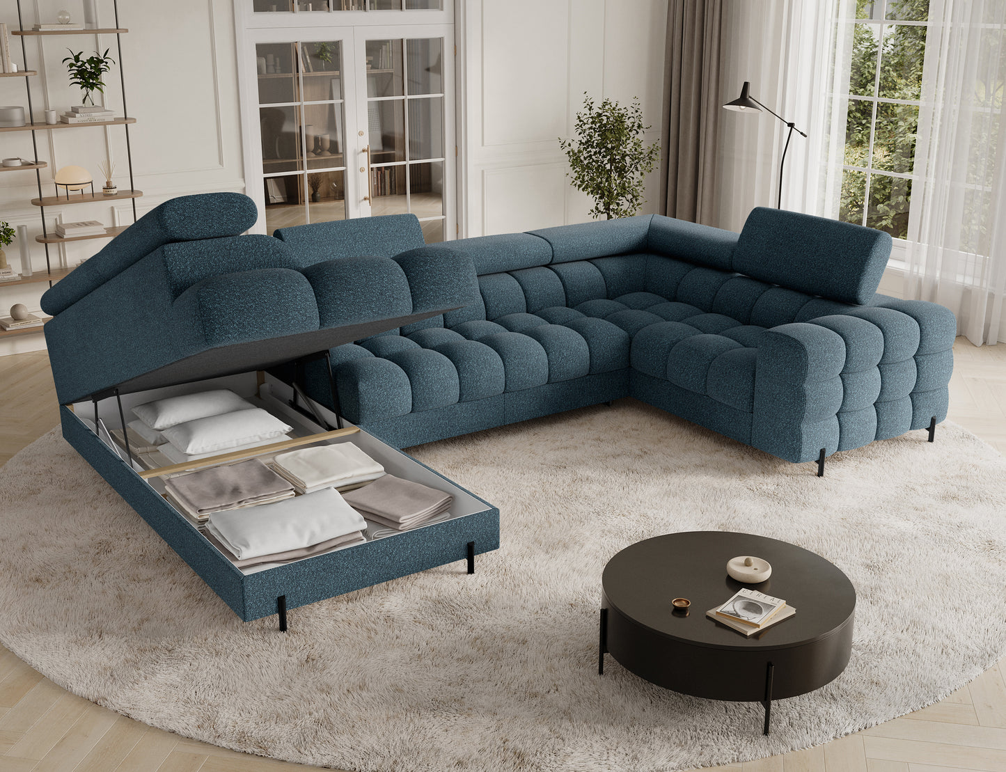 Narożnik Fectory w niebieskim odcieniu, z podniesioną częścią, ukazującą pojemnik na pościel, zapewniający dodatkową przestrzeń do przechowywania.