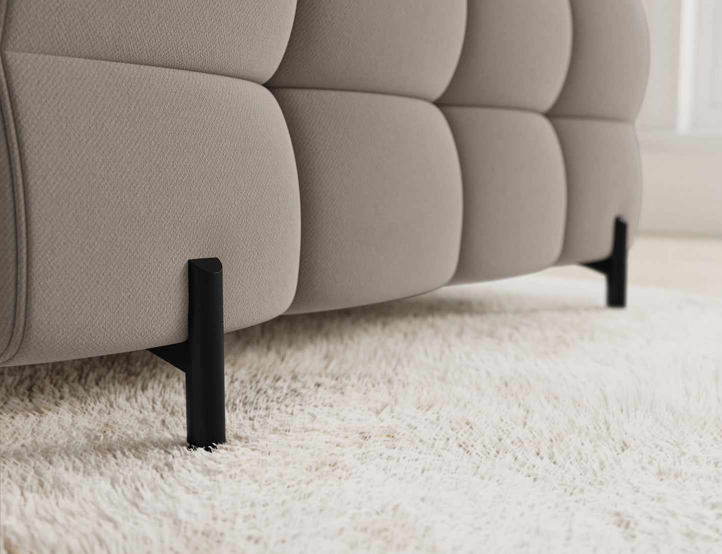 Metalowe nogi w narożniku Fectory zapewniają stabilność i elegancki wygląd, a ich kolor kontrastuje z beżową tkaniną.