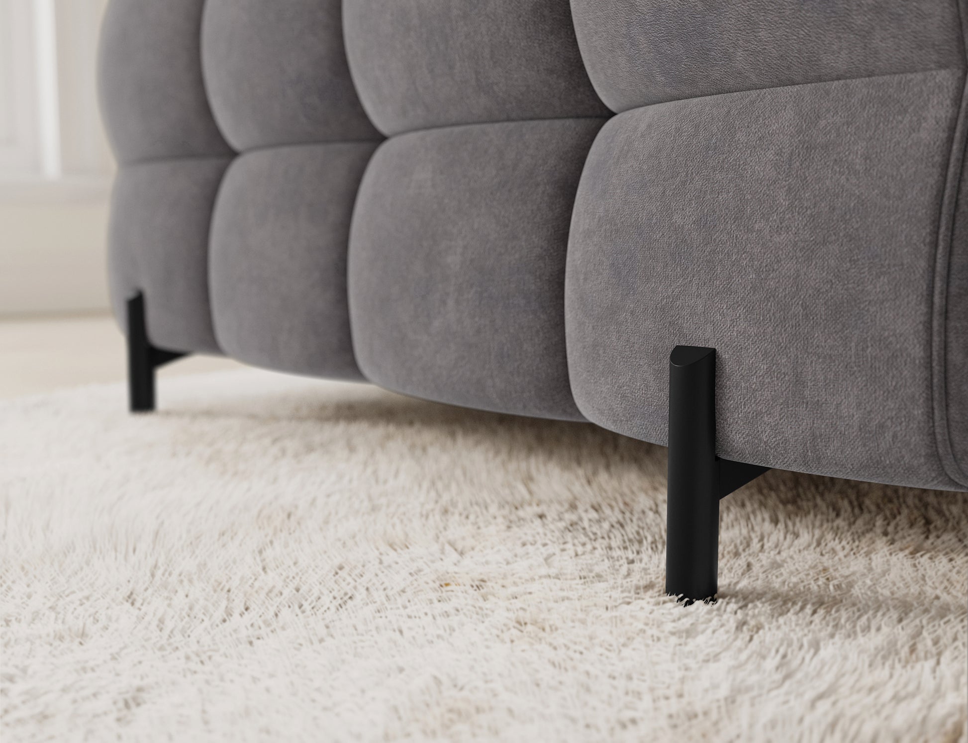 Zbliżenie na narożnik Fectory w szarości, z widoczną funkcją spania, która zapewnia komfort i funkcjonalność.