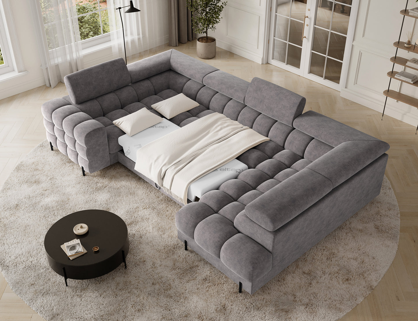 Narożnik Fectory w szarym kolorze z funkcją spania, z rozłożoną częścią, prezentującą komfortową powierzchnię do odpoczynku.