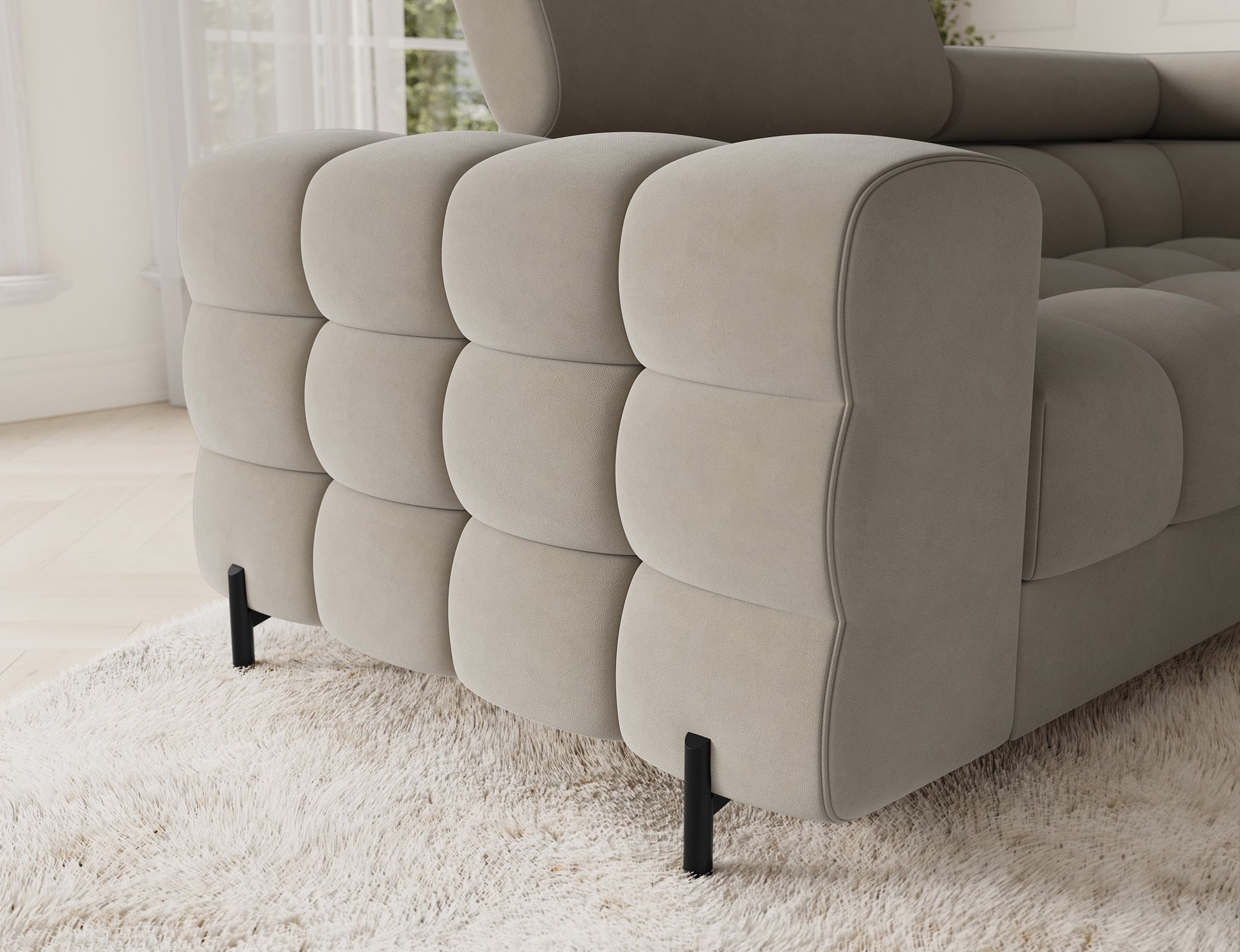 Narożnik Fectory prawy Aura 18 kremowy – detal podłokietnika z głębokim pikowaniem, smukłe czarne nogi, elegancki wygląd