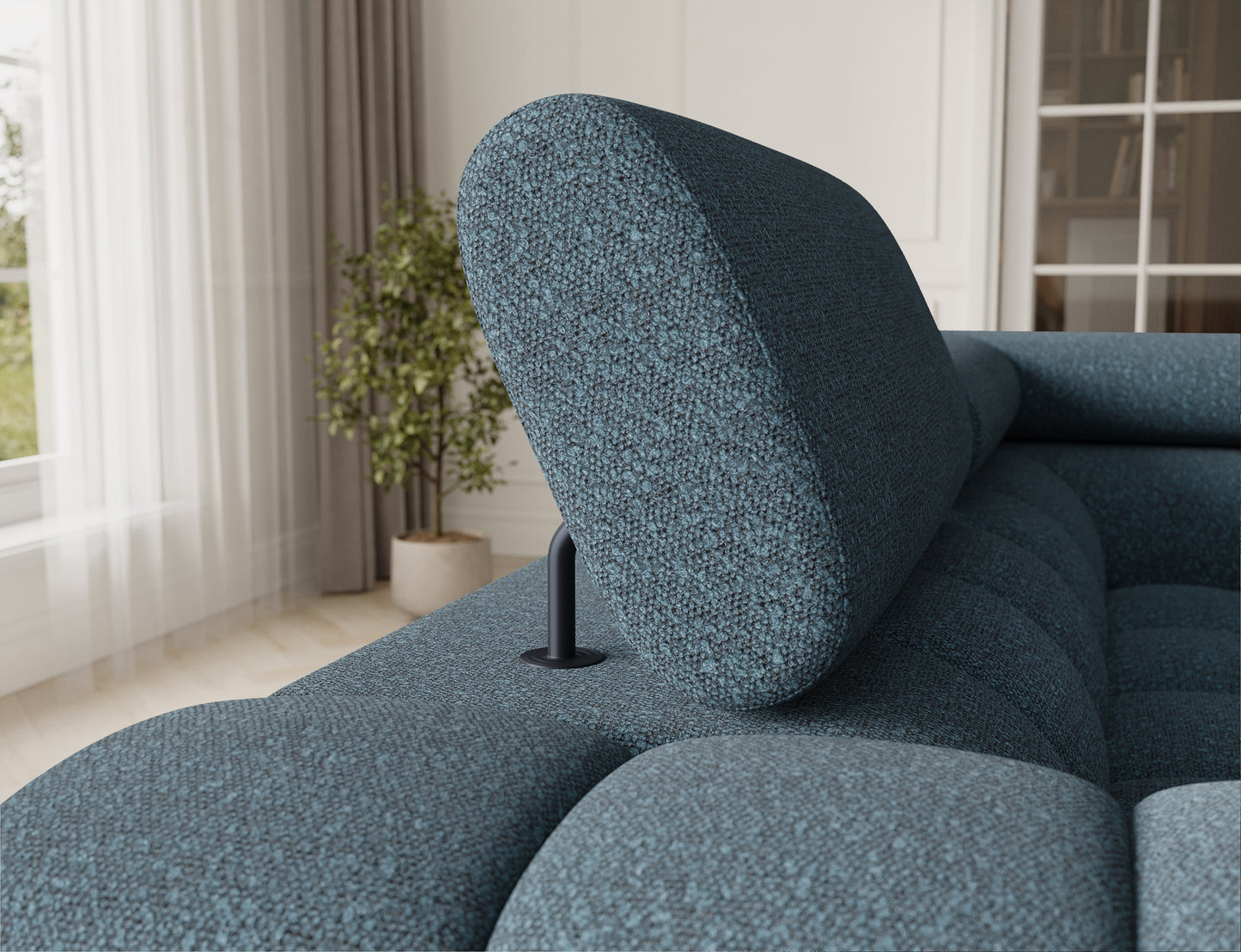 Zbliżenie na zagłówek narożnika Fectory w niebieskim odcieniu, z regulowaną częścią, zapewniającą komfort i wygodę.