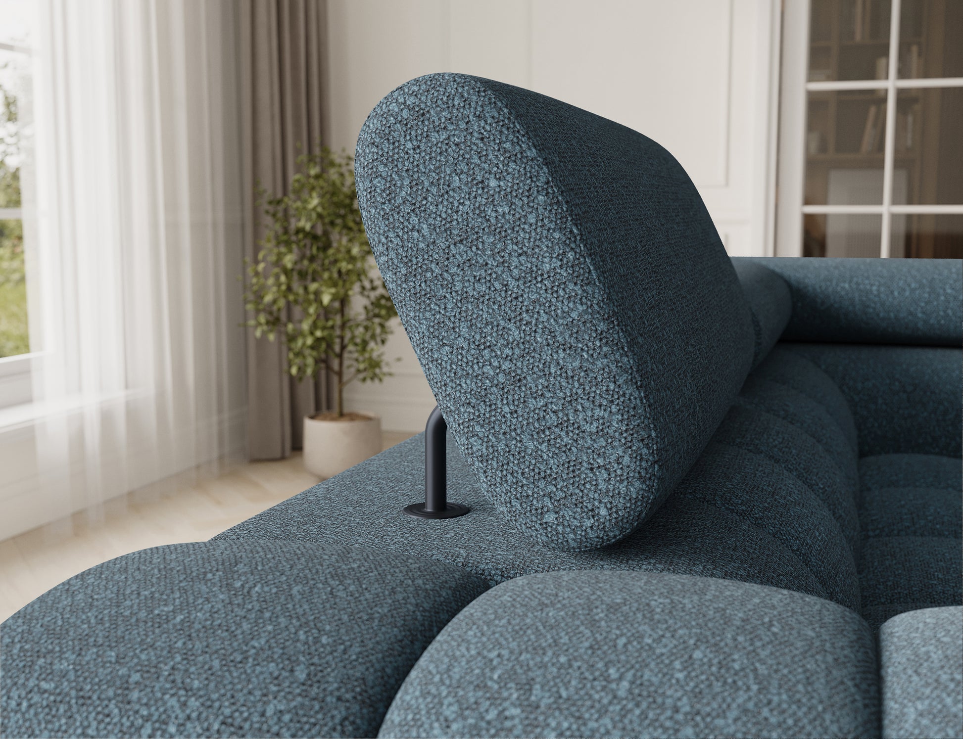 Zbliżenie na zagłówek narożnika Fectory w niebieskim odcieniu, z regulowaną częścią, zapewniającą komfort i wygodę.