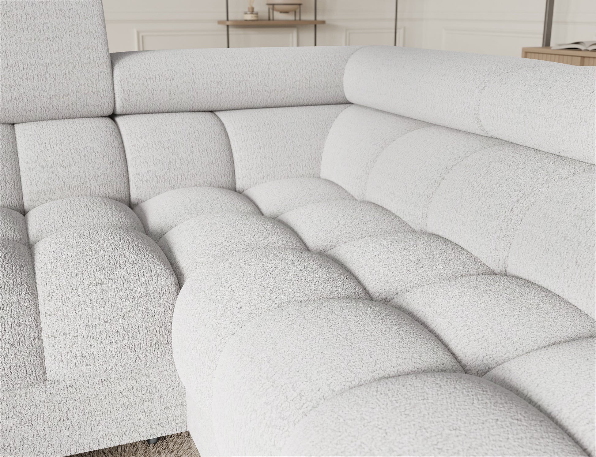 Detal narożnika Fectory w białym kolorze, z widokiem na starannie wykończone siedzisko, podłokietnik i eleganckie nogi.