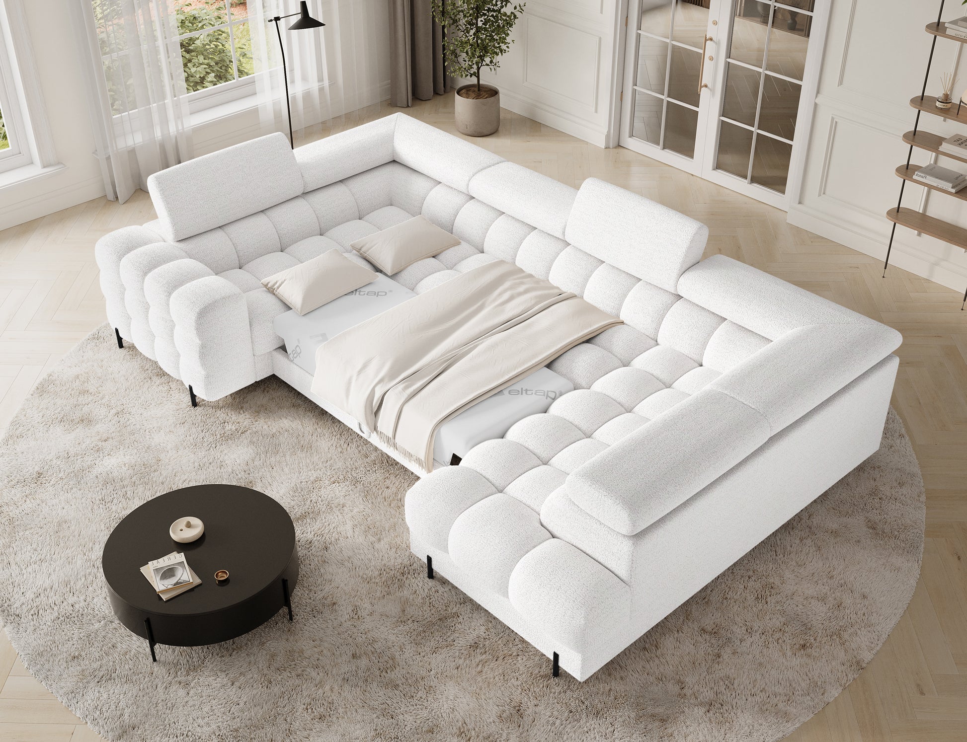 Narożnik Fectory lewy, biały z funkcją spania, widok z góry z rozłożoną powierzchnią do spania i poduszkami.