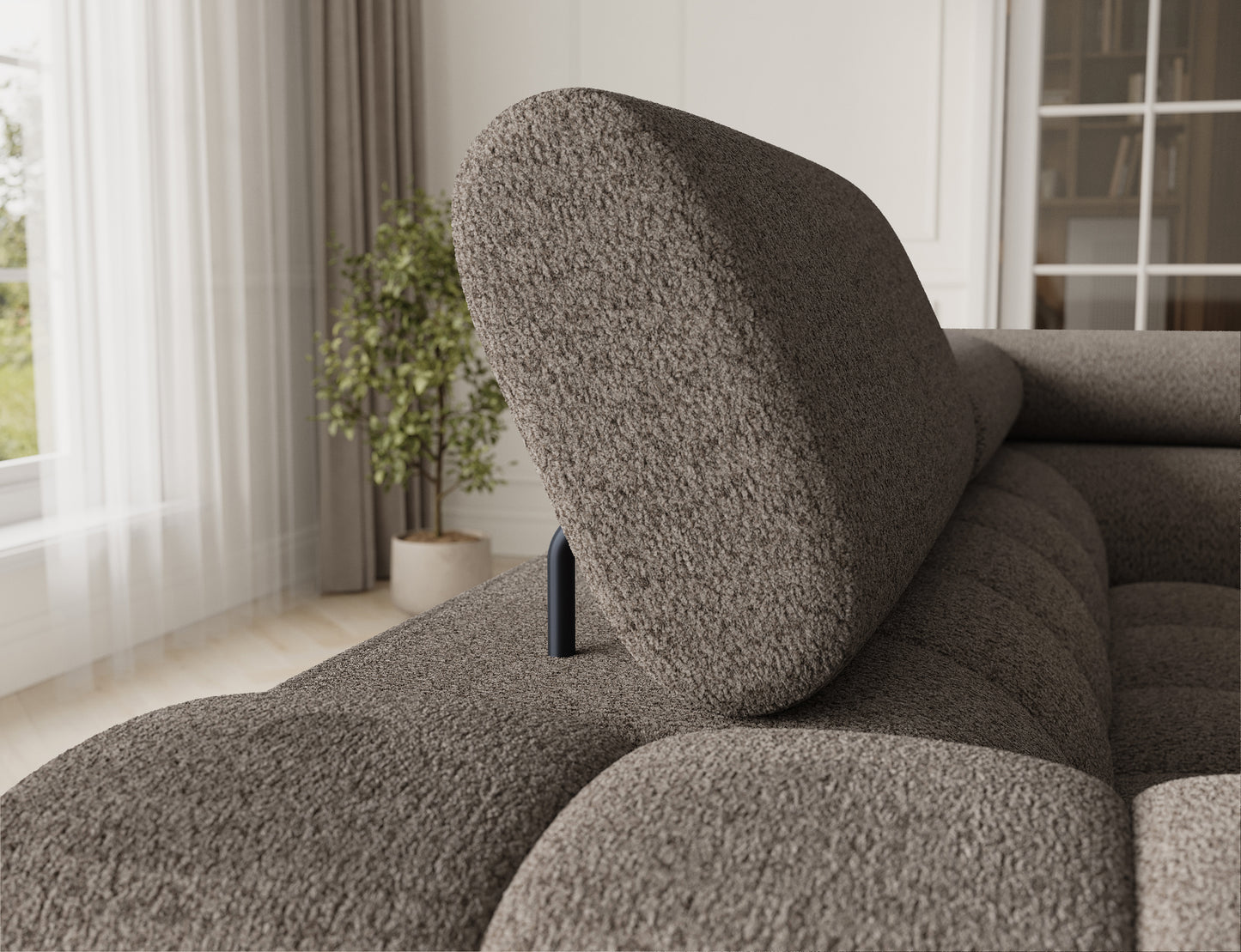 Widok na oparcie sofy, które jest elegancko zaokrąglone, a materiał ma strukturę, która dodaje przytulności.