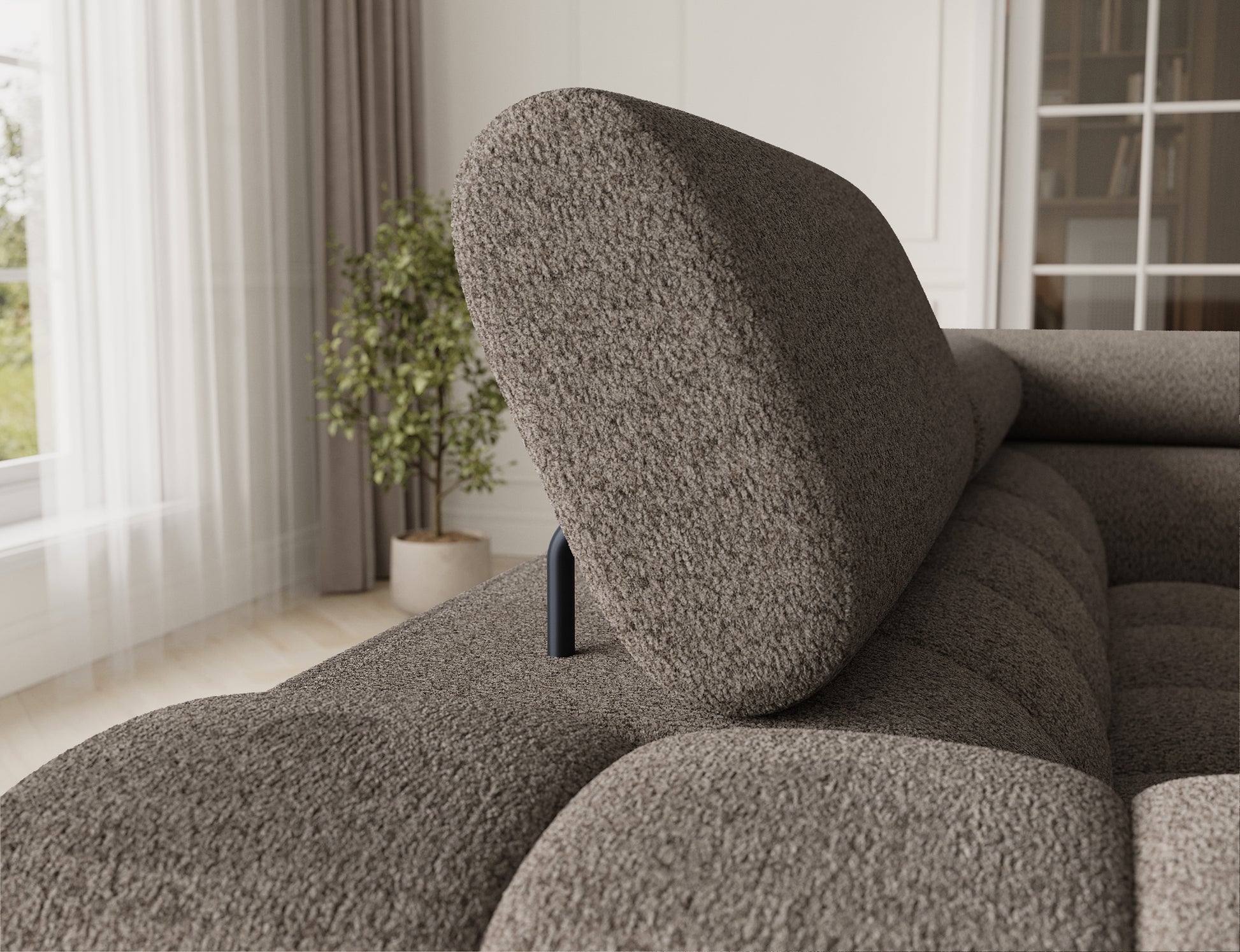 Widok na oparcie sofy, które jest elegancko zaokrąglone, a materiał ma strukturę, która dodaje przytulności.