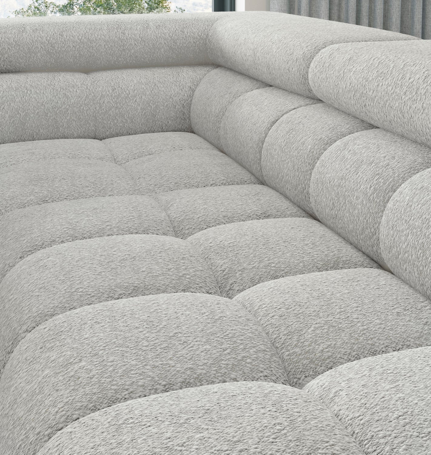 Ujęcie narożne przedstawiające miękkie pikowania i strukturę tkaniny Royal 03 na siedzisku i oparciu narożnika Ferucce.