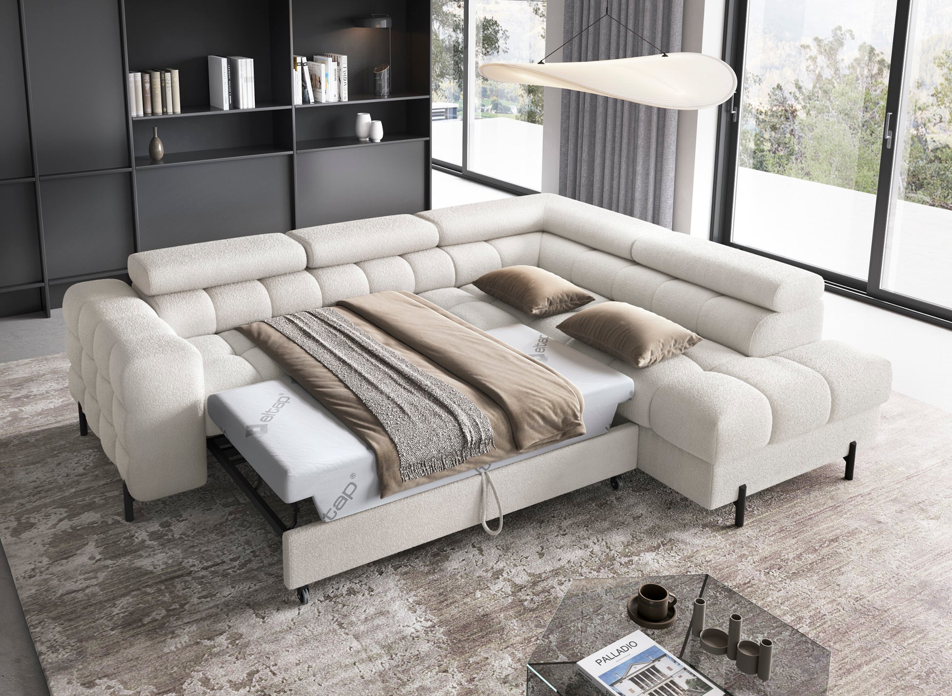 Narożnik Ferucce Amore 01 biały z funkcją spania – rozłożony, z pościelą, w nowoczesnym salonie z widokiem przez duże okna.