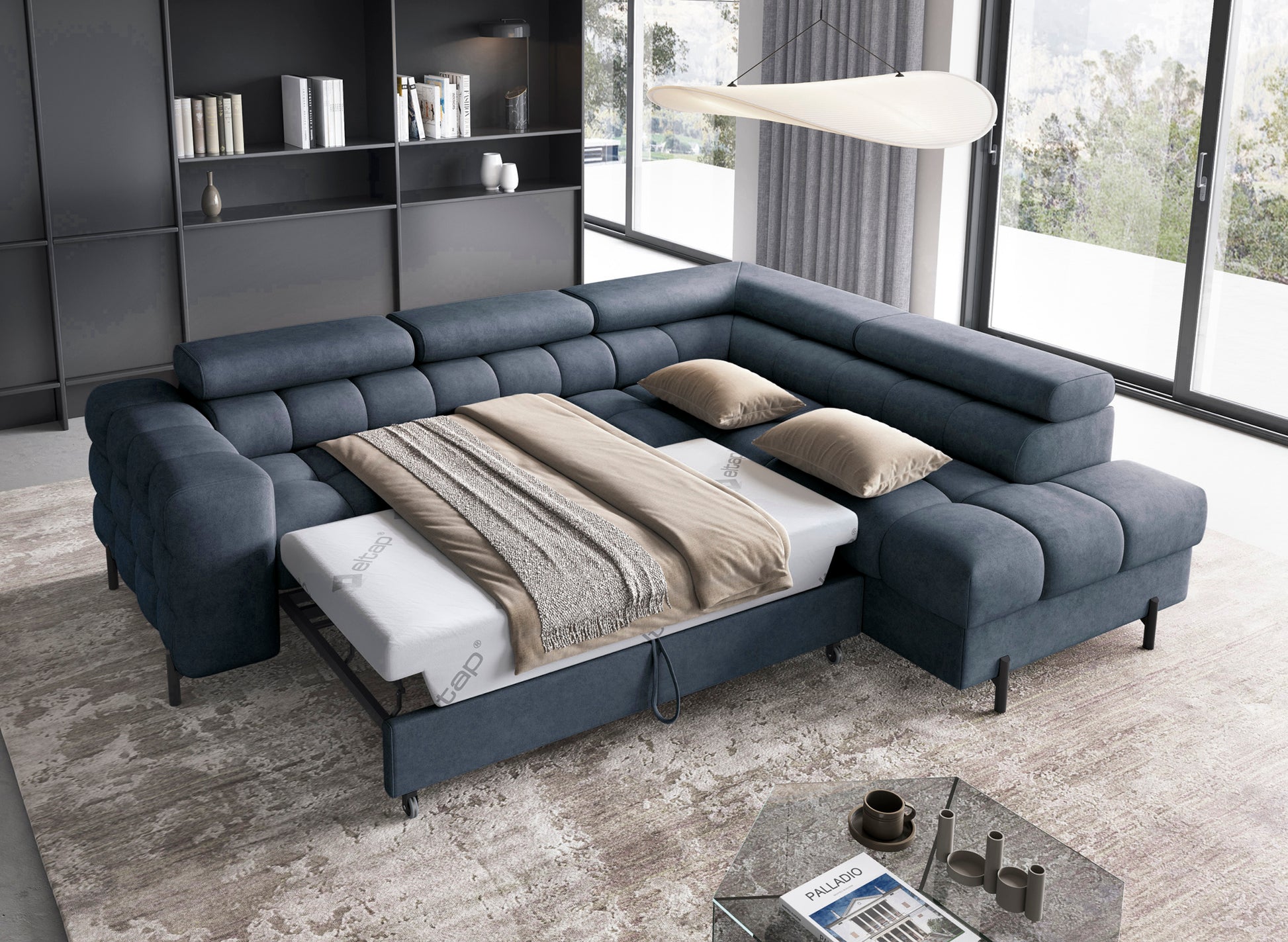 Rozłożony narożnik Ferucce z funkcją spania, widoczna powierzchnia do snu z pościelą i zagłówkami w pozycji pionowej.