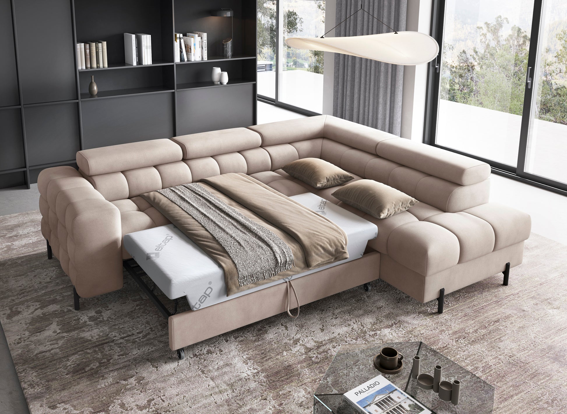 Rozłożony narożnik Ferucce z funkcją spania, widoczna przestrzeń do nocnego wypoczynku z pościelą i zagłówkami.