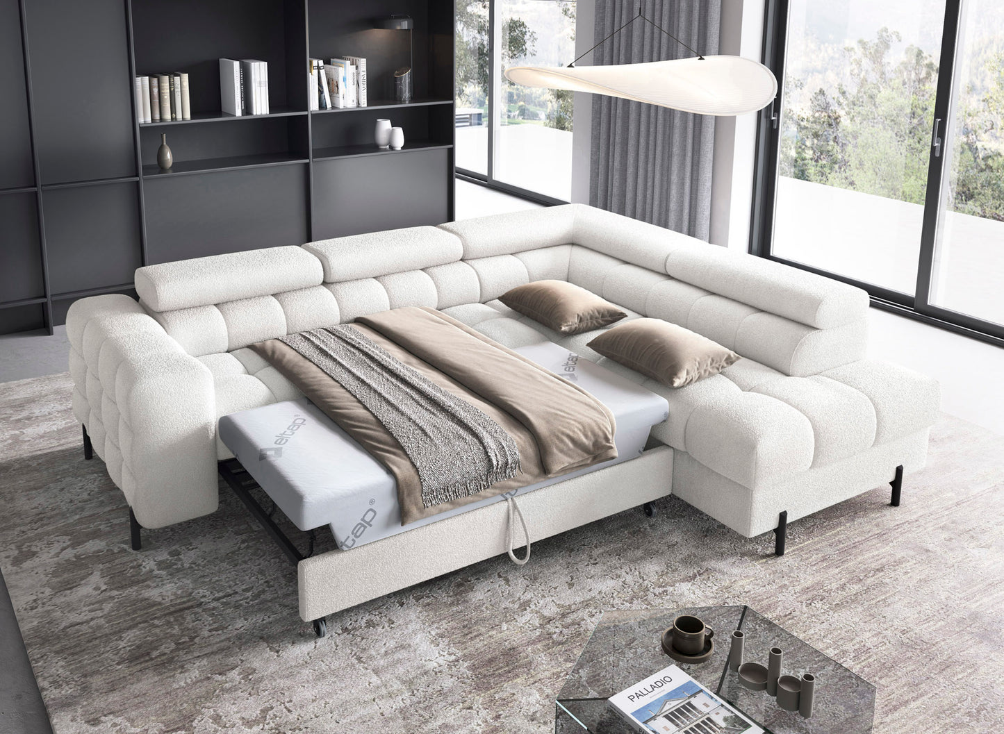 Narożnik Ferucce biały z funkcją spania, rozłożony do pozycji łóżka, widoczna pościel oraz materace z logo ELTAP w eleganckim, jasnym wnętrzu.