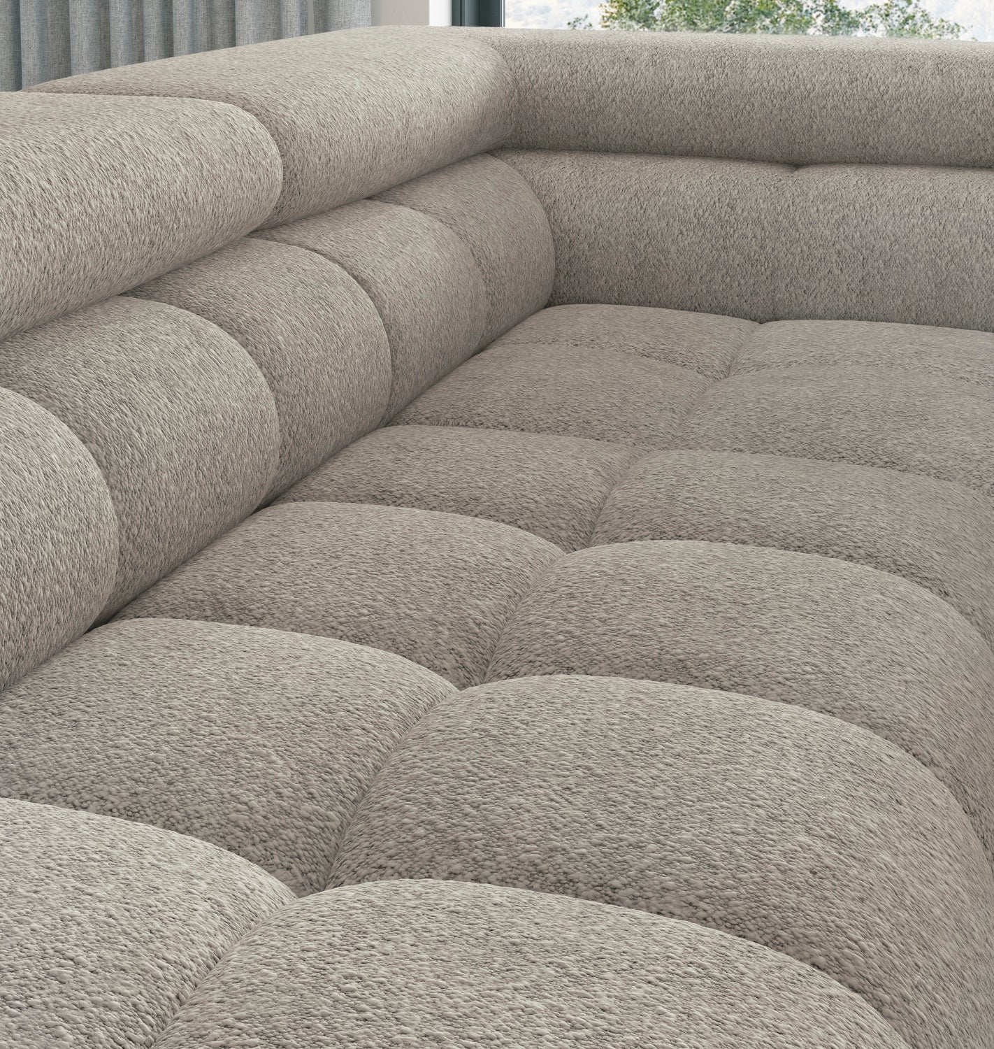 Detal siedziska narożnika Ferucce, tkanina Royal 20 beżowy – pikowana powierzchnia w miejscu łączenia modułów narożnych.