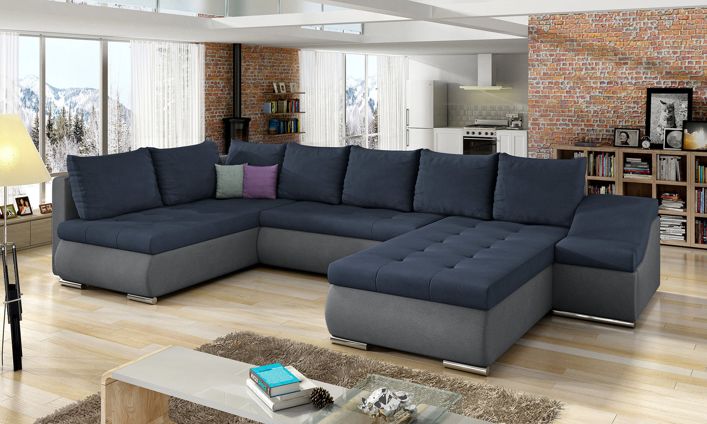 Narożnik Giovanni granatowo-ciemnoszary w nowoczesnym salonie, narożna sofa modułowa przy ceglanej ścianie