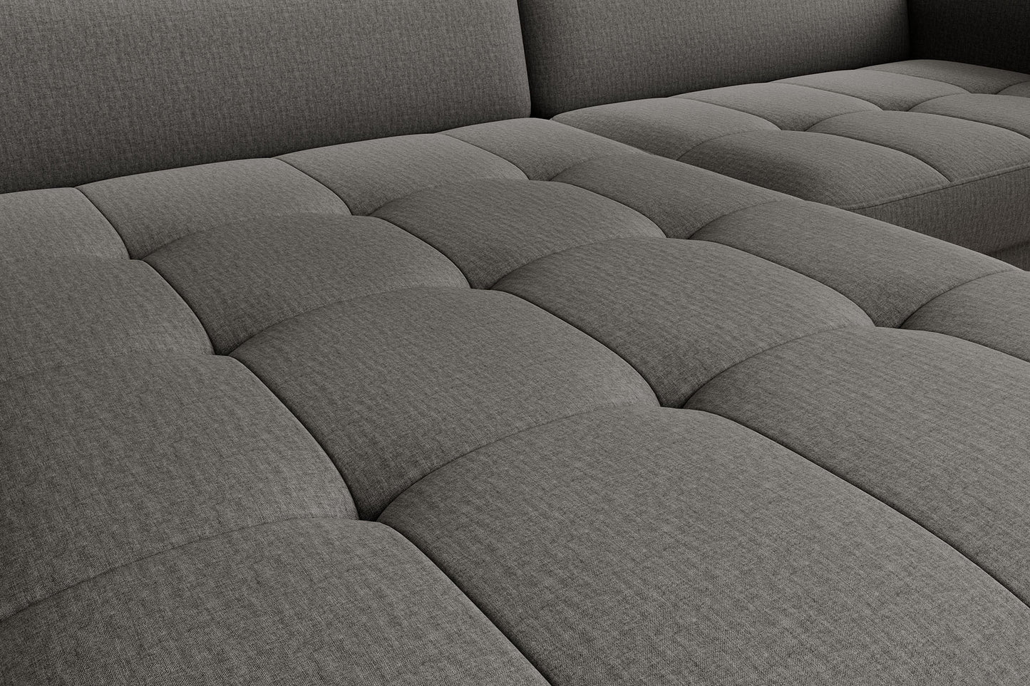 Zbliżenie na pikowaną tkaninę – detal siedziska narożnika Gomsi w kolorze szarym Manhattan 06, wielowymiarowy wzór przeszyć.