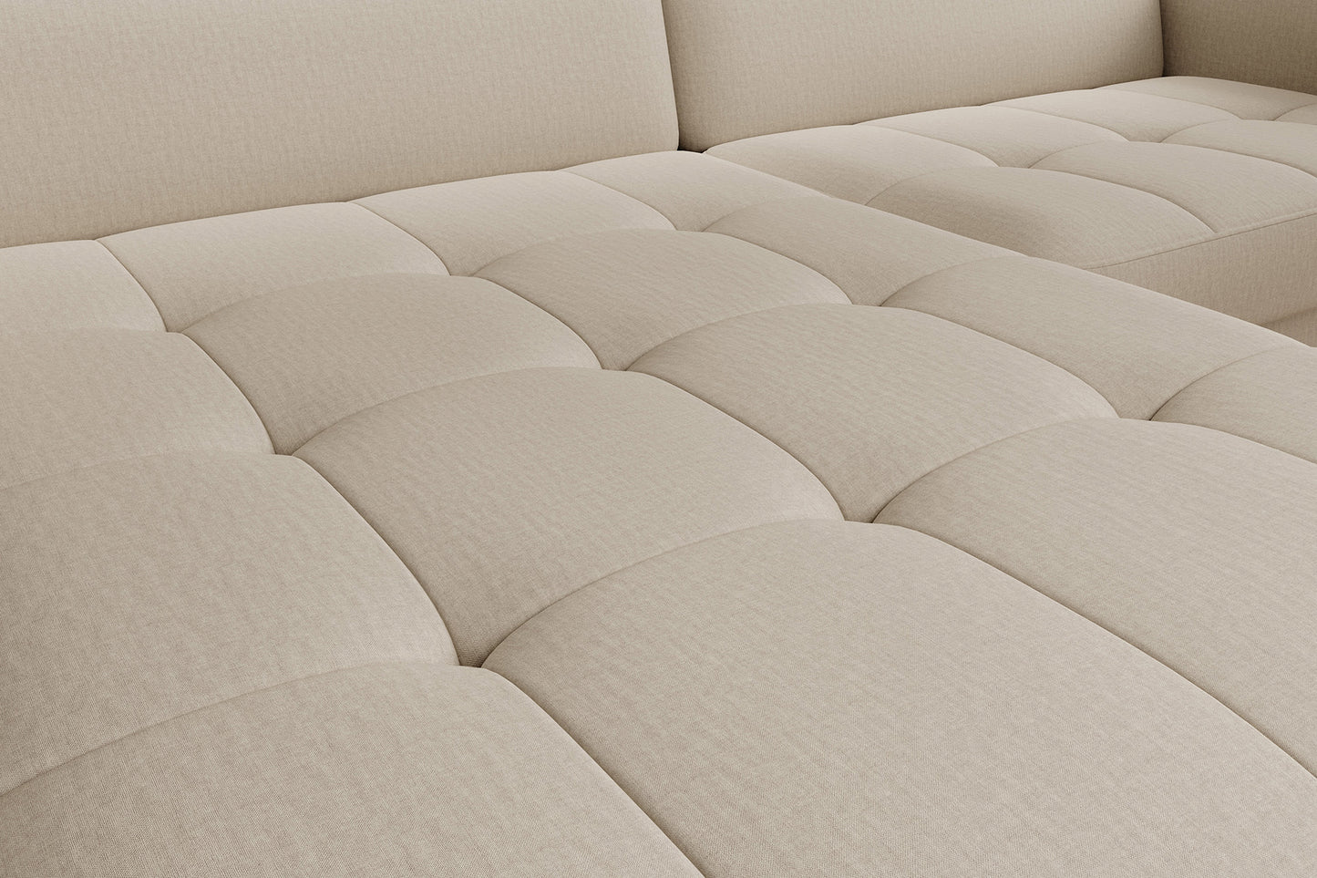 Zbliżenie na pikowane siedzisko – detal faktury tkaniny i regularnych przeszyć narożnika Gomsi Manhattan 18 jasnobeżowy.