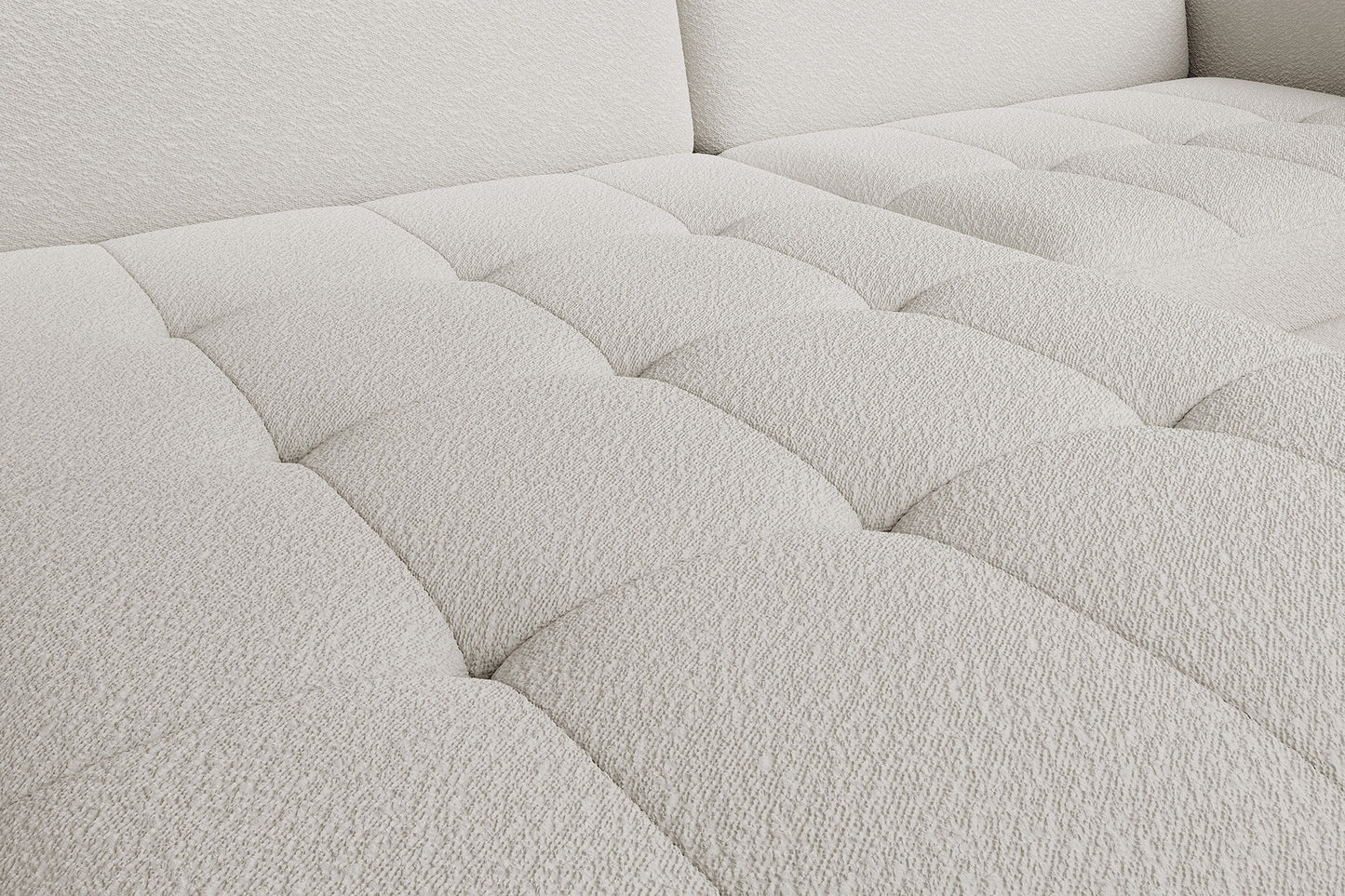 Zbliżenie na pikowane, miękkie siedzisko narożnika Gomsi Royal 01 biały w układzie lewym.