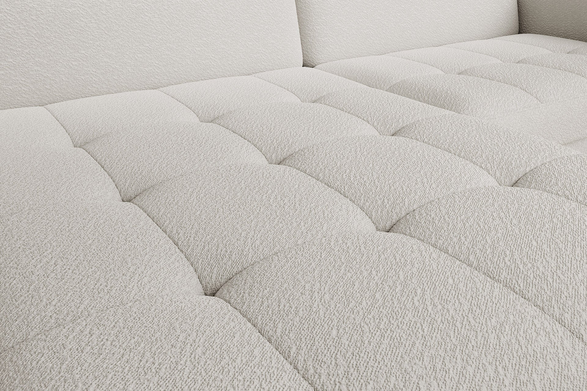 Zbliżenie na pikowane, miękkie siedzisko narożnika Gomsi Royal 01 biały w układzie lewym.