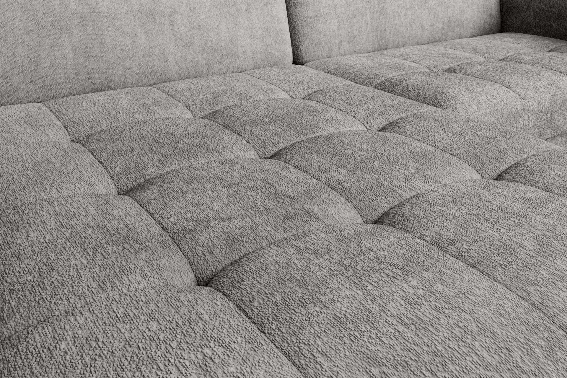 Zbliżenie na pikowane siedzisko narożnika Gomsi Raquel 03 jasnoszary w układzie lewym, pokazujące detale przeszyć i fakturę miękkiej tkaniny.