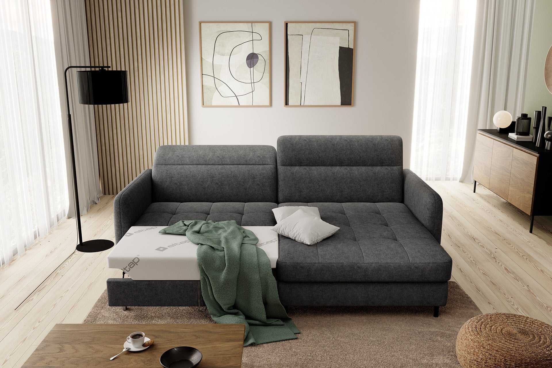 Czarny narożnik Gomsi Raquel 05 w układzie prawym, skośne ujęcie z lewej strony we wnętrzu salonu z dekoracjami.