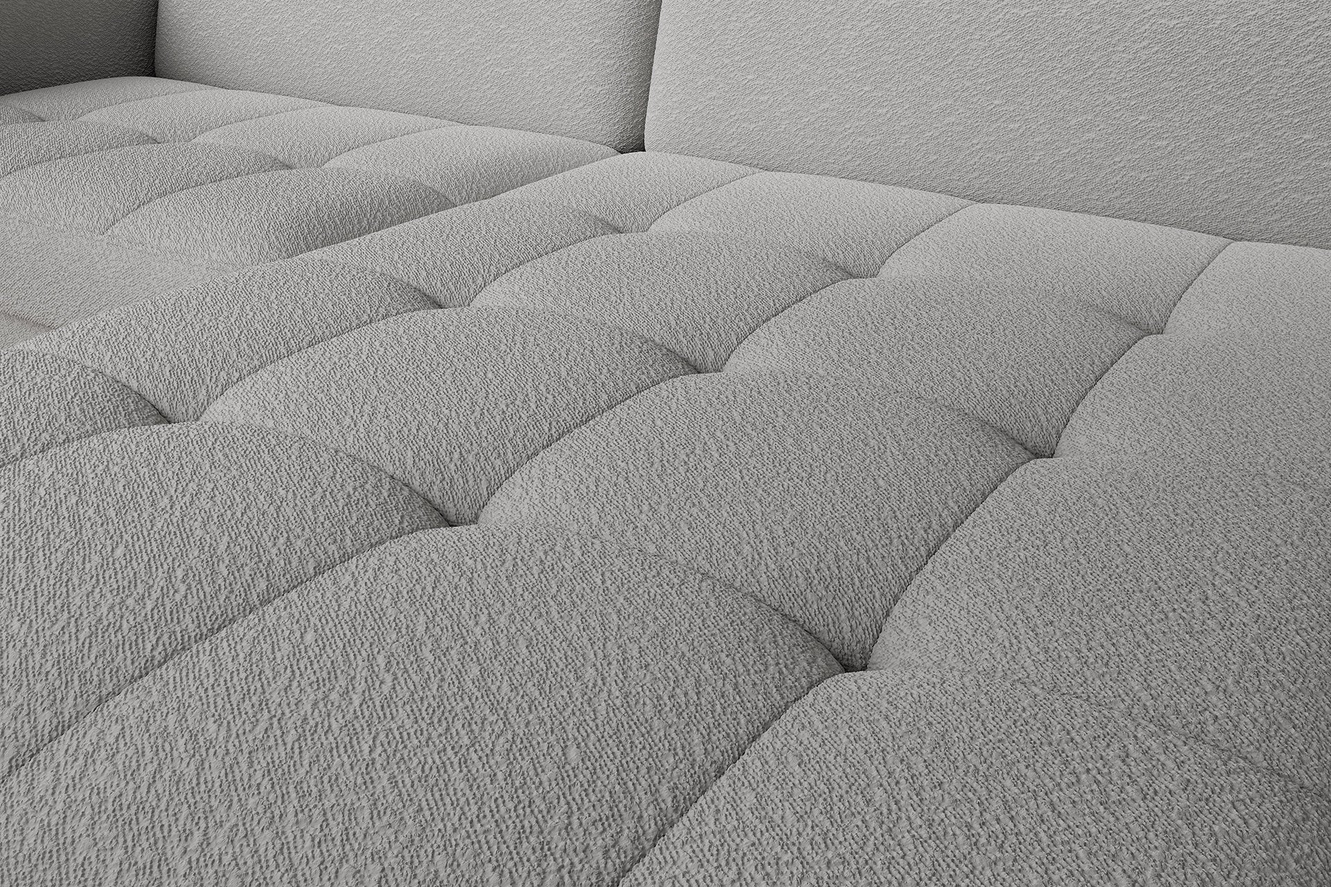 Zbliżenie na pikowane siedzisko narożnika Gomsi Royal 04 szary, ukazujące miękką, subtelną fakturę tkaniny.