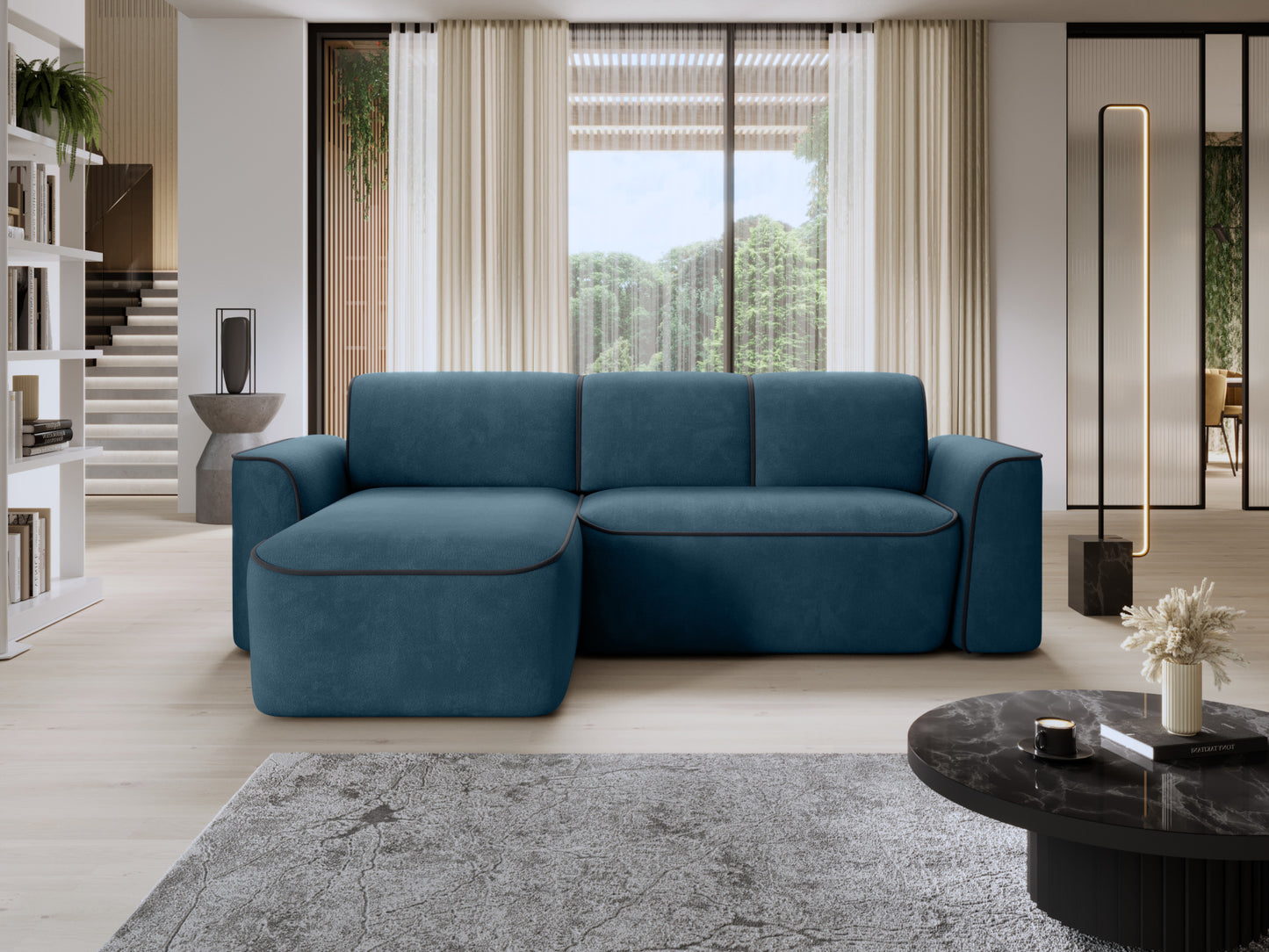 Narożnik Ume w układzie lewym w Amore 40 granatowym z lamówką Velvetmat 06 ciemnoszarą, ustawiony w nowoczesnym salonie przy dużym oknie.