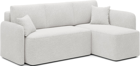 Jasny narożnik tapicerowany z szezlongiem i poduszkami – nowoczesny design do salonu.