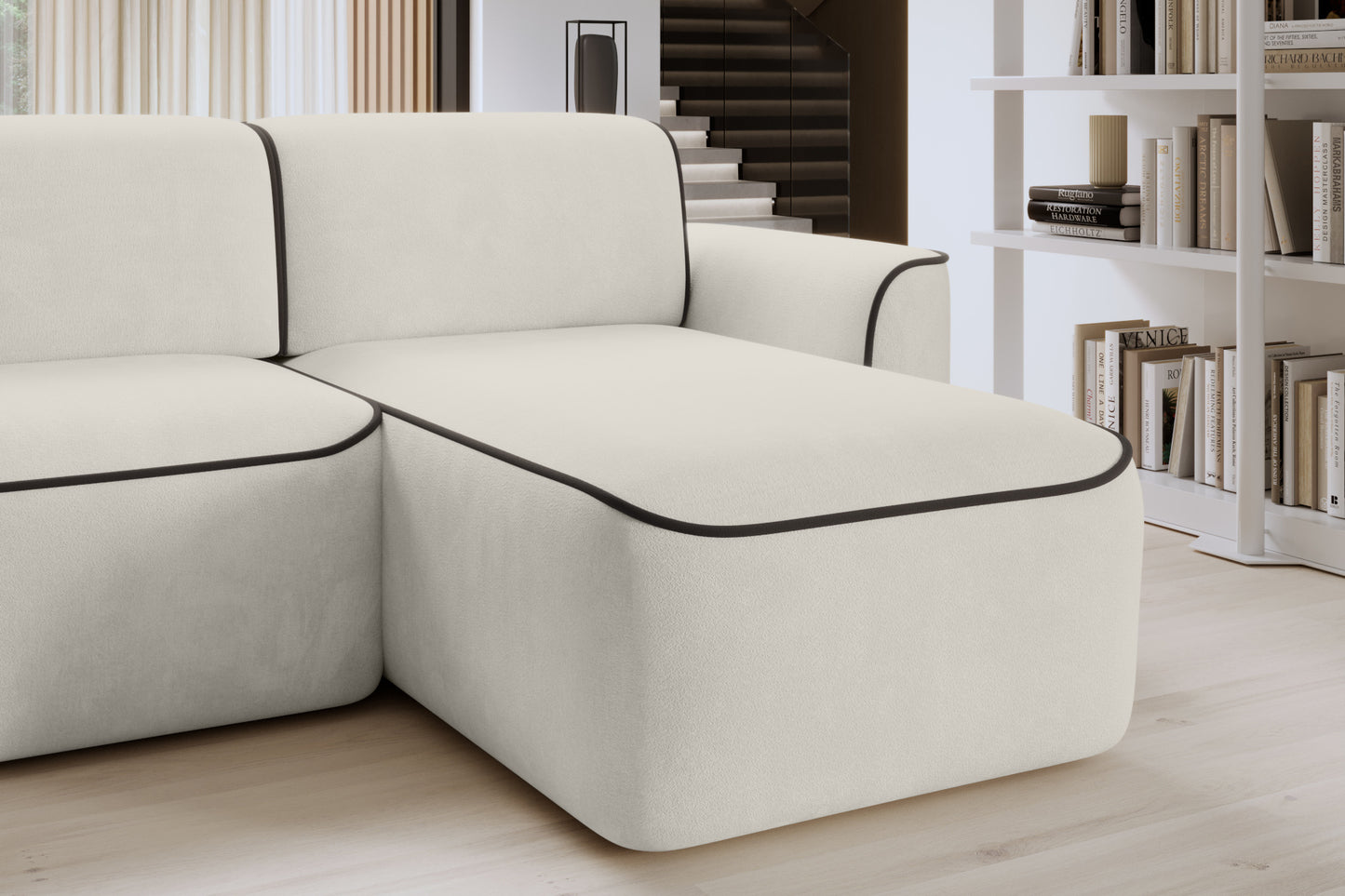 Detal tylnej części oparcia narożnika Ume Amore 01 jasnobeżowy z lamówką Velvetmat 22 brązową, widoczny regał na książki w tle.