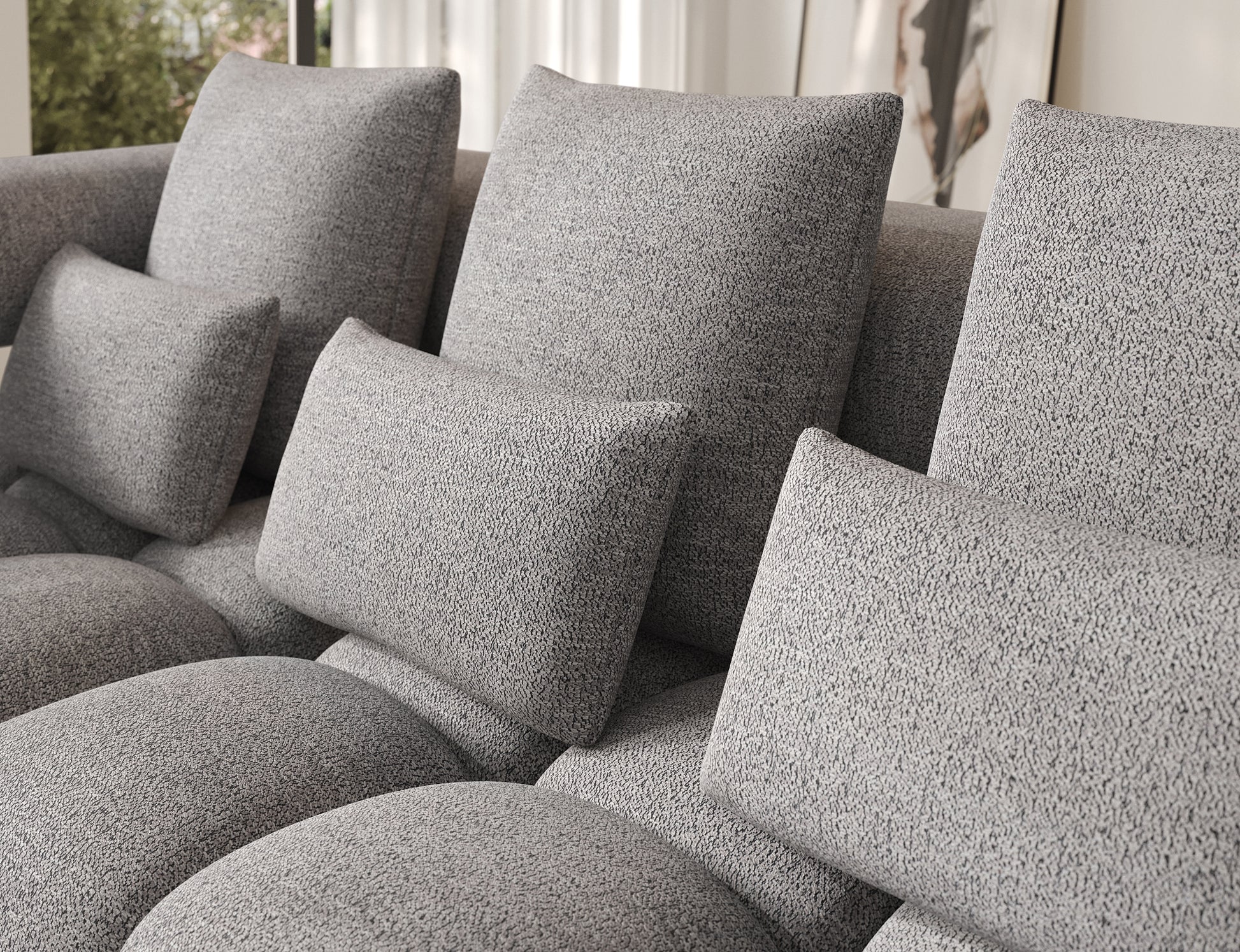 Zbliżenie na poduszki oparciowe narożnika Levvi lewy ELTAP w tkaninie Coralline 03 szaro-czarny boucle, miękkie i wygodne