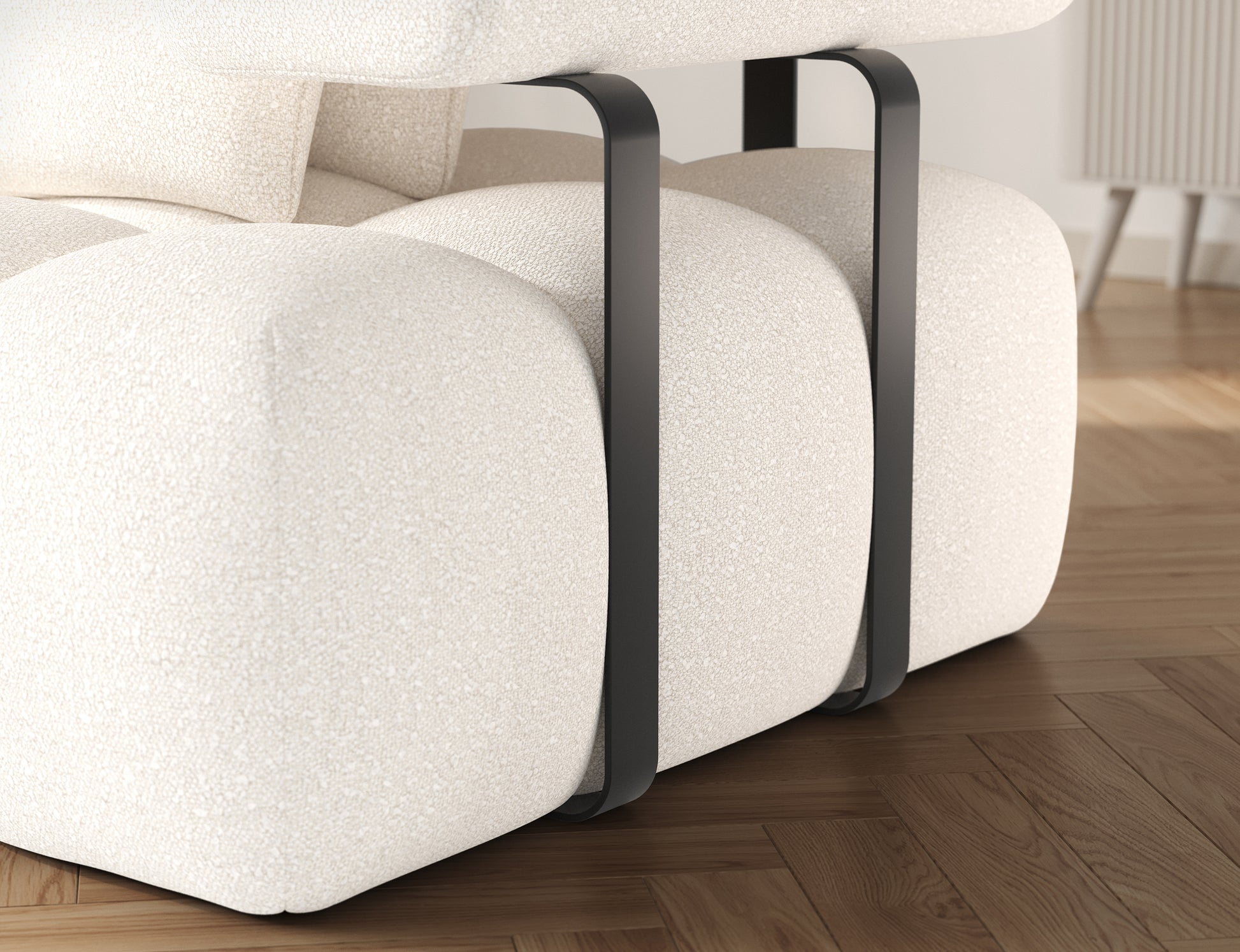 Detal metalowego elementu w narożniku Levvi w tkaninie Jaffray 01 białej – solidne, nowoczesne wykończenie w kontrastowej czerni.