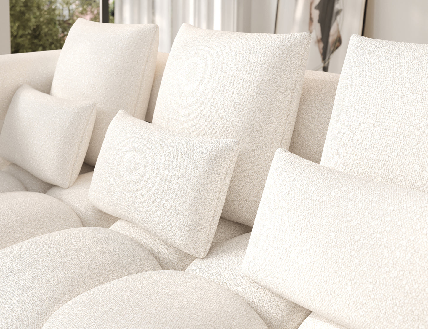 Zbliżenie na poduszki narożnika Levvi w tkaninie Jaffray 01 białej – miękkie oparcie i przyjemna w dotyku tekstura bouclé.