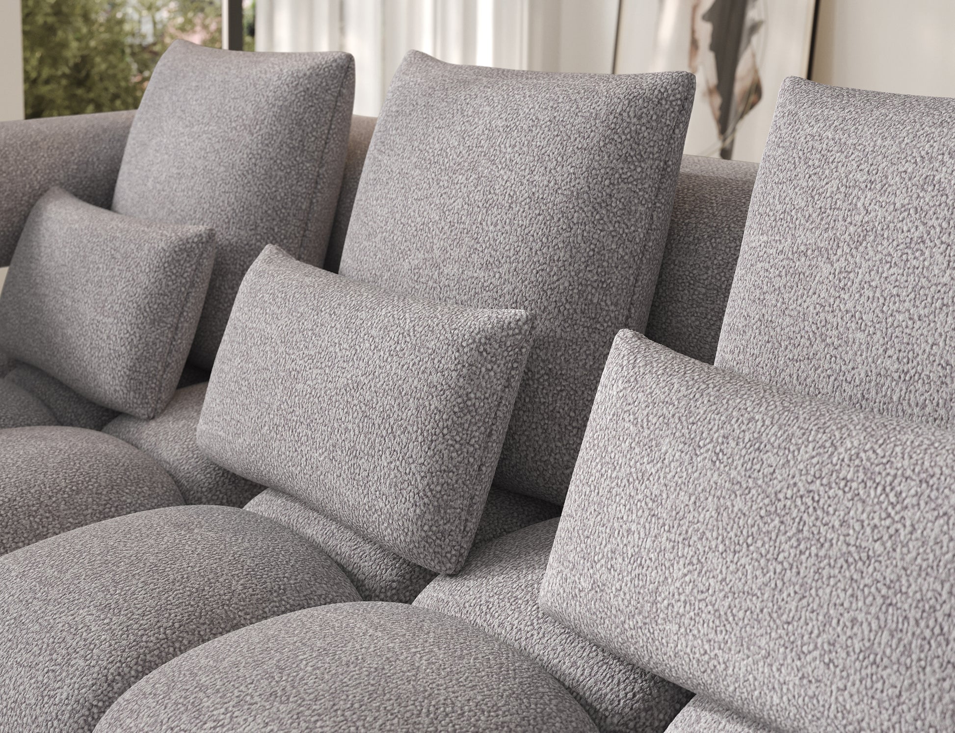 Detal poduszek narożnika Levvi lewy Paolli 04 szary – miękka, przyjemna w dotyku tkanina boucle zapewniająca wyjątkowy komfort.