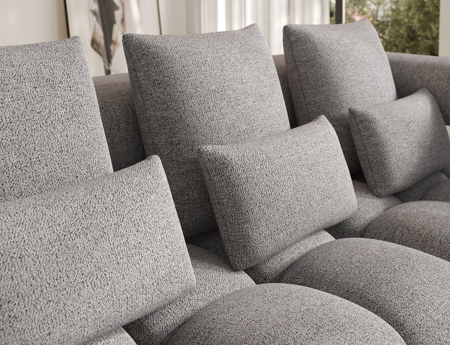 Zbliżenie na miękkie poduszki oparcia w narożniku Levvi prawym ELTAP, tkanina boucle Coralline 03 szaro-czarna.