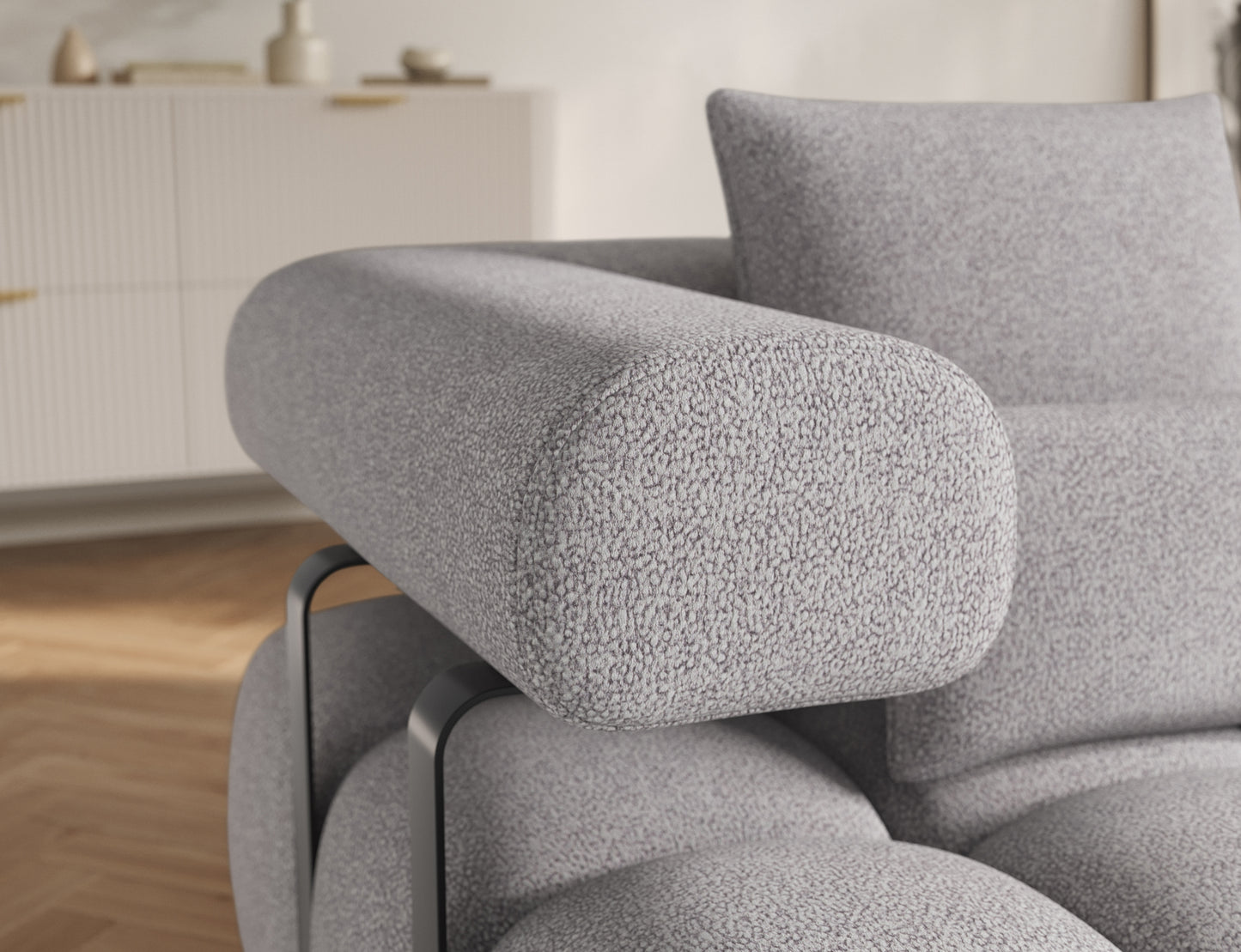 Zbliżenie na podłokietnik narożnika Levvi Paolli 04 szary – zaokrąglony kształt i nowoczesne metalowe detale.