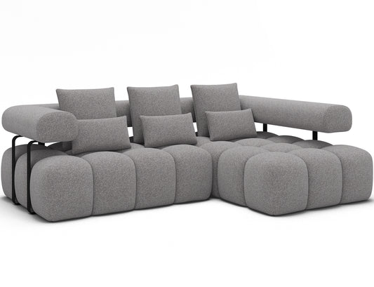 Narożnik Levvi prawy w tkaninie Paolli 04 szary prezentowany pod skosem – nowoczesna forma i miękkie siedziska.