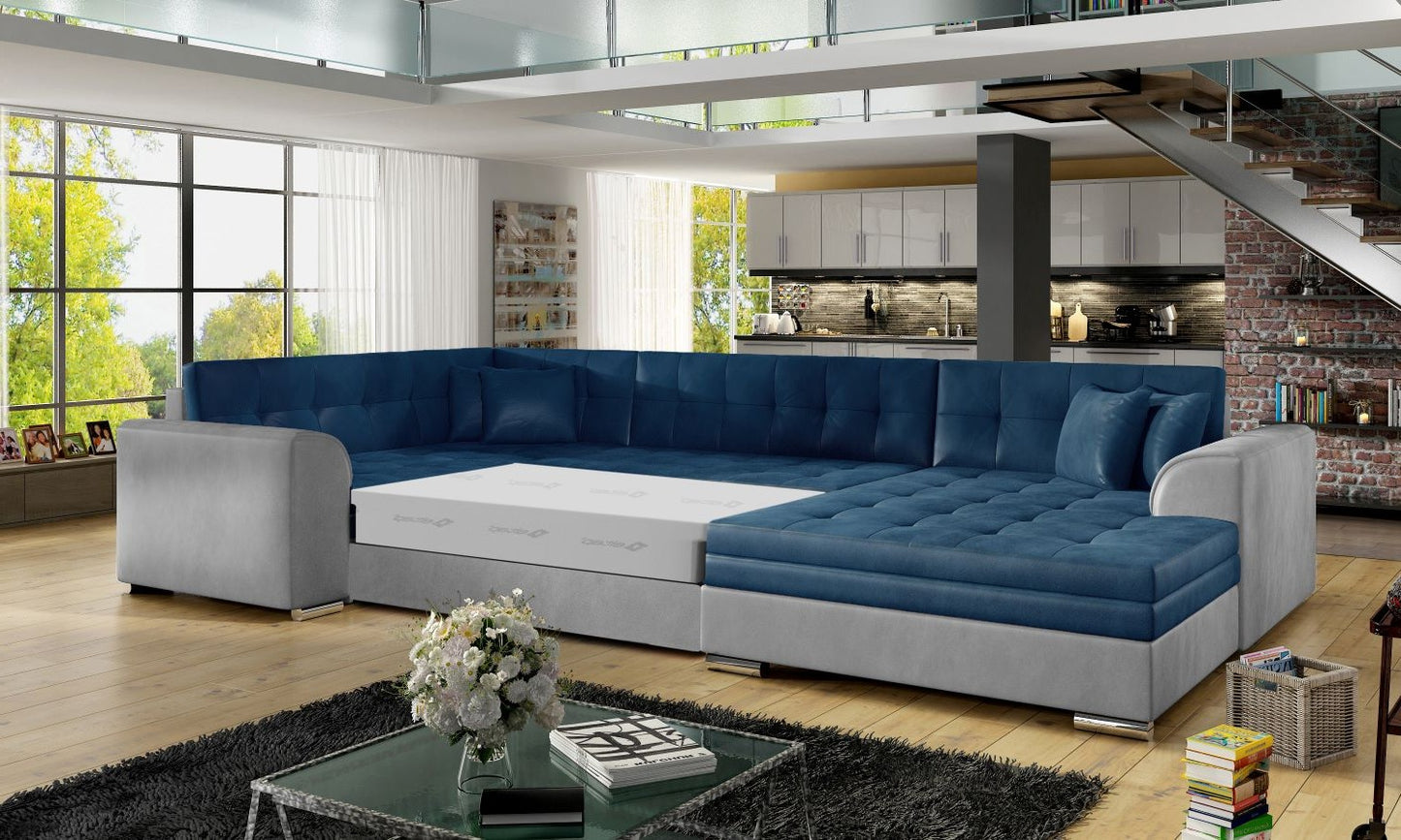 Narożnik Damario w kolorze niebieskim i jasnoszarym z rozłożoną funkcją spania, prezentacja przestronnej powierzchni do wypoczynku.