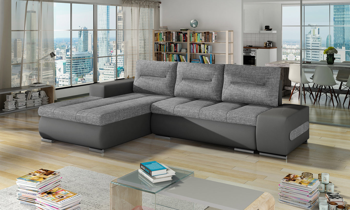 Narożnik Ottavio w układzie lewym, tkanina Sawana 21 szary i Soft 29, w nowoczesnym salonie z dużymi oknami.