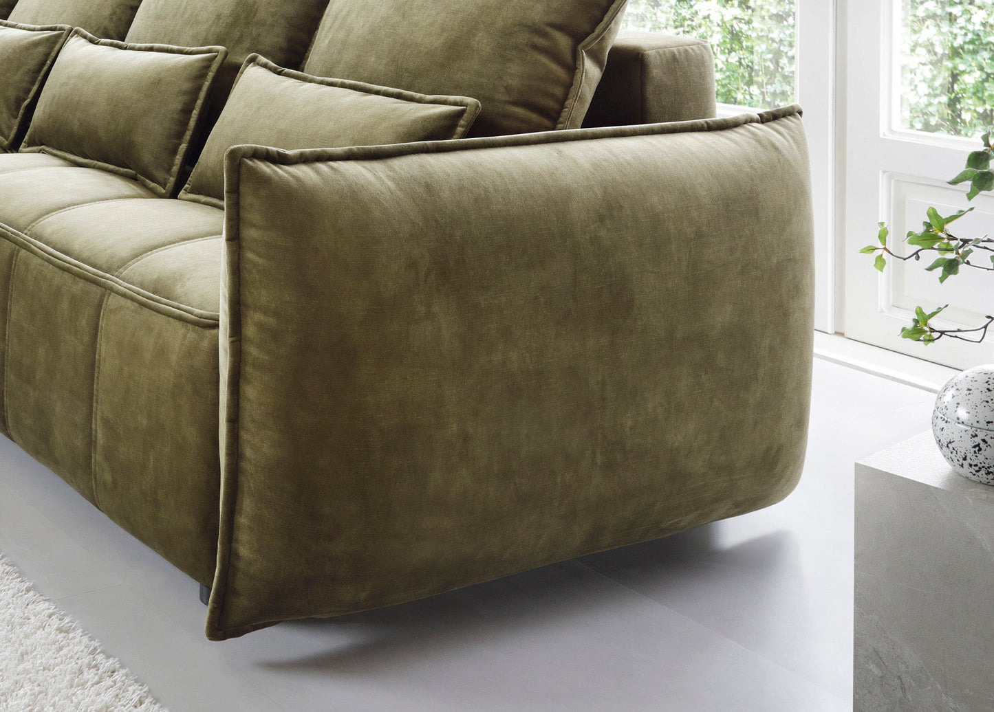 Zbliżenie lewego bocznego panelu narożnika Campo Toscana 33 zielonego w układzie lewym, podkreślające miękkie obszycie i zaokrąglony kształt podłokietnika.