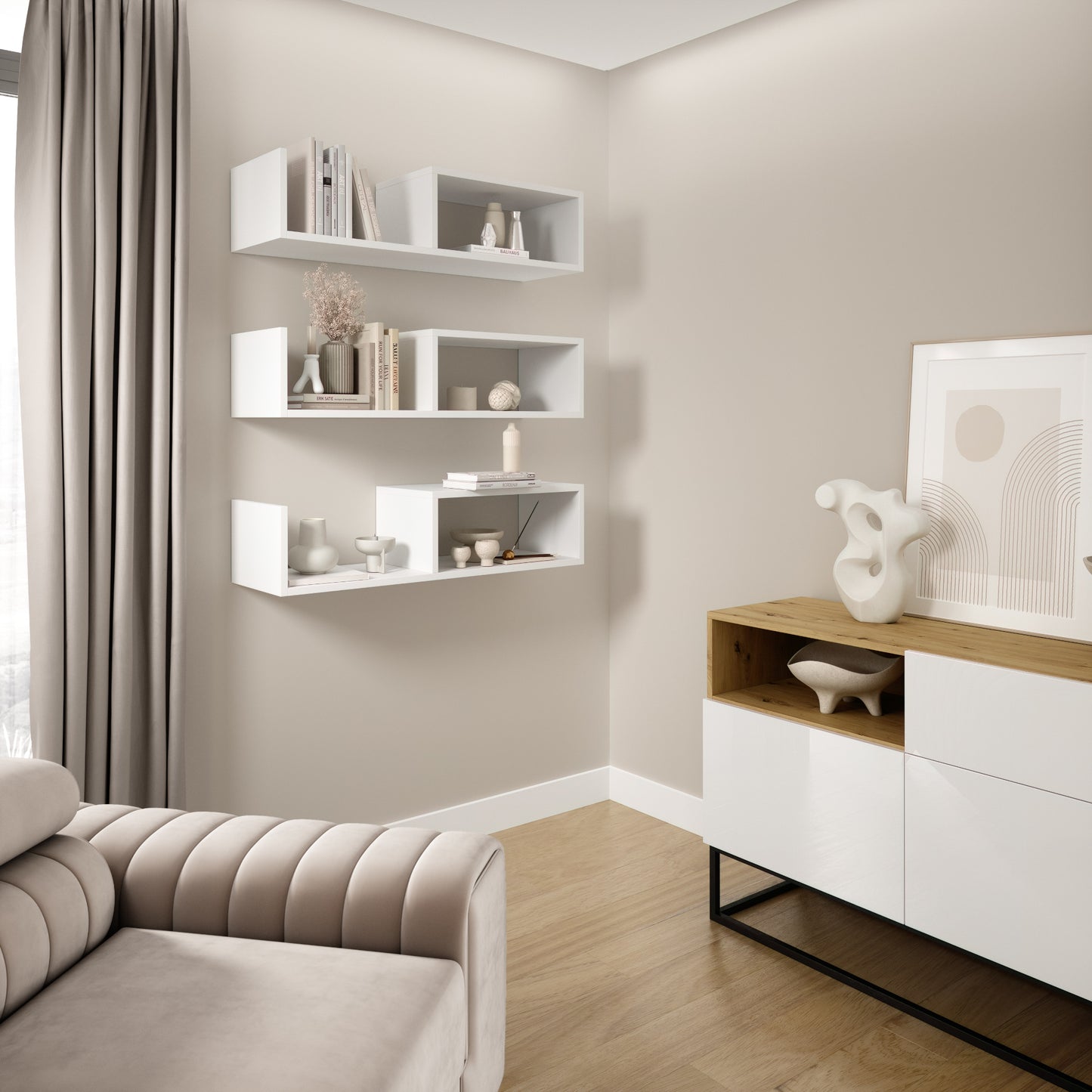 Widok wnętrza z trzema białymi modułami Vellia zamontowanymi w narożniku pokoju, wypełnionymi książkami i dekoracjami nad niską konsolą.